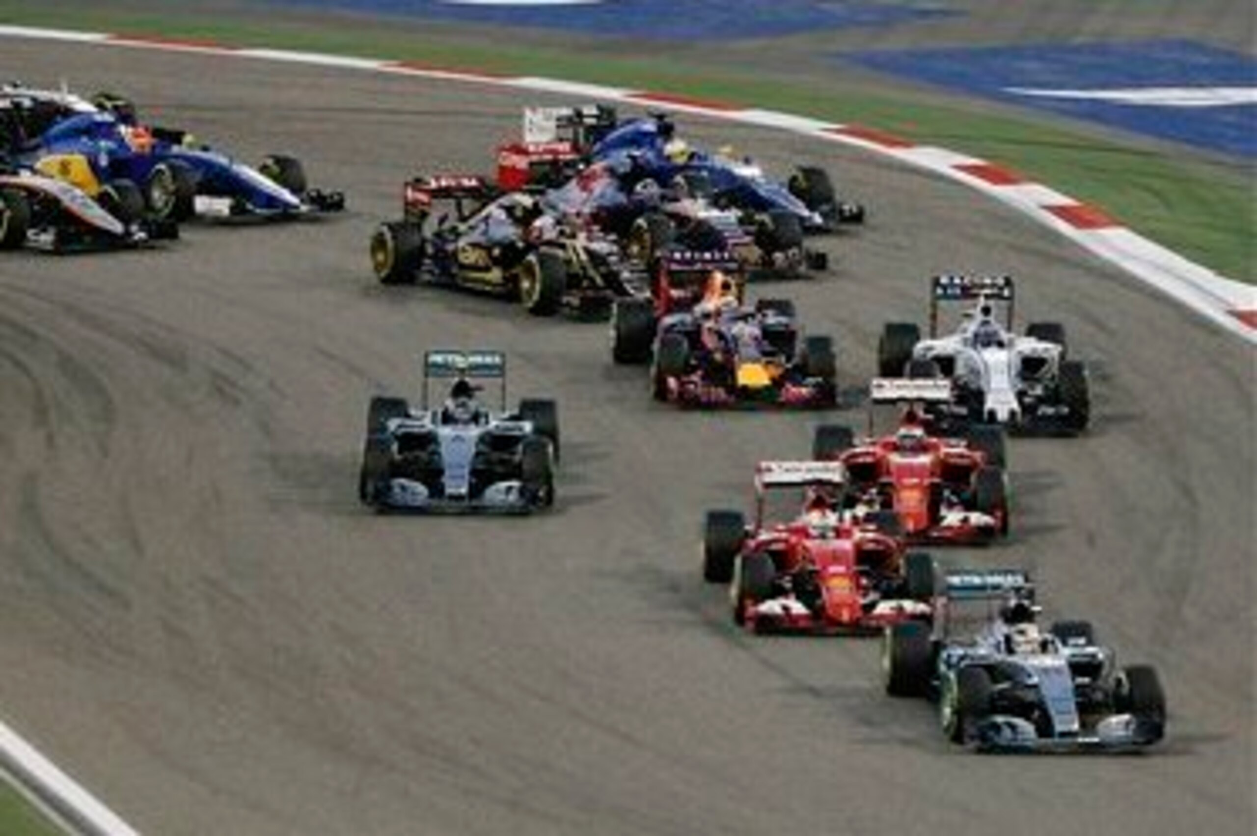 Hamilton leads at the start with the Ferraris and Rosberg following.