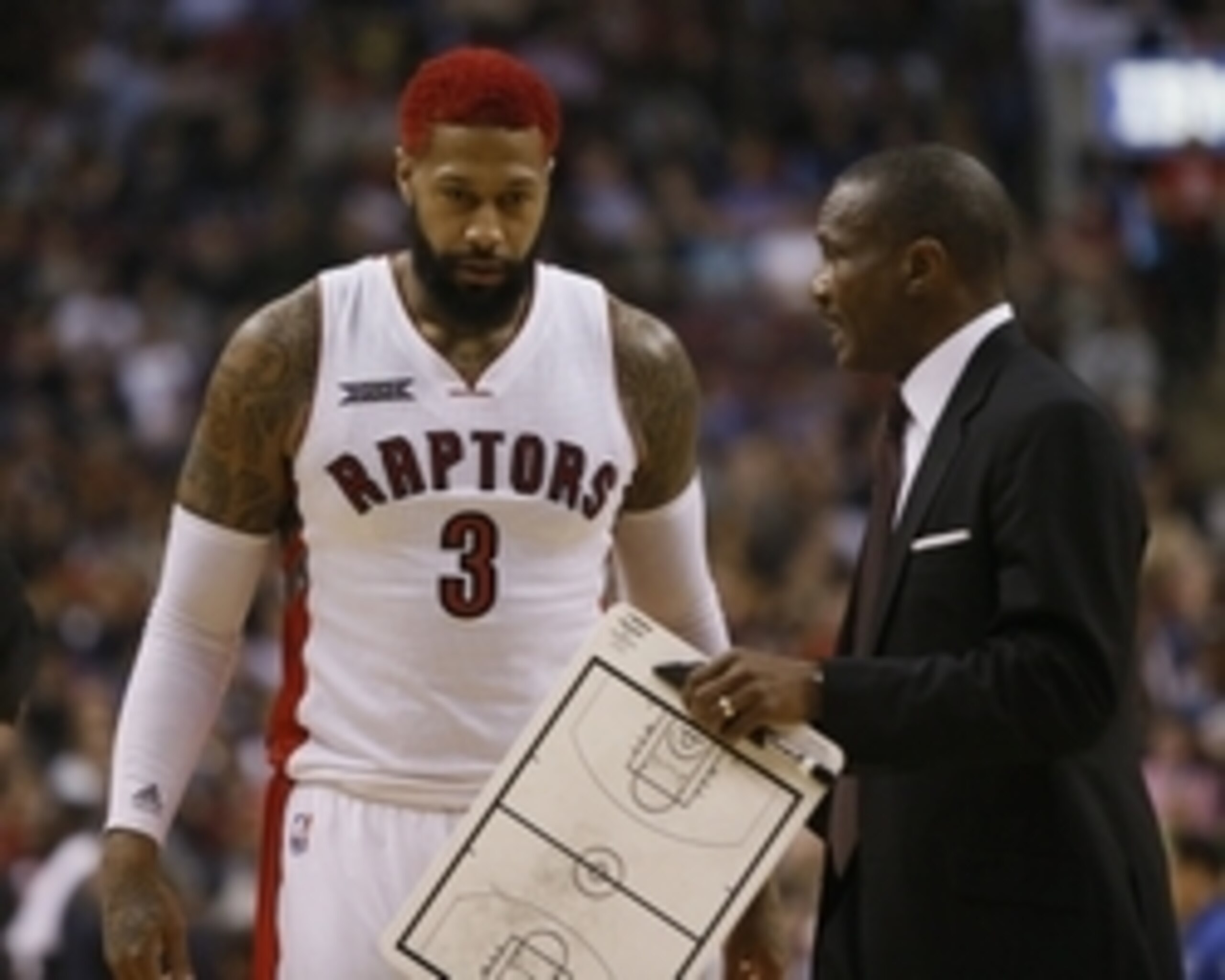 Apr 15, 2015; Toronto, Ontario, CAN; Toronto Raptors head coach Dwane Casey (R) talks to forward James Johnson (3) during a stoppage in play against the Charlotte Hornets during the first half at the Air Canada Centre. Mandatory Credit: John E. Sokolowski