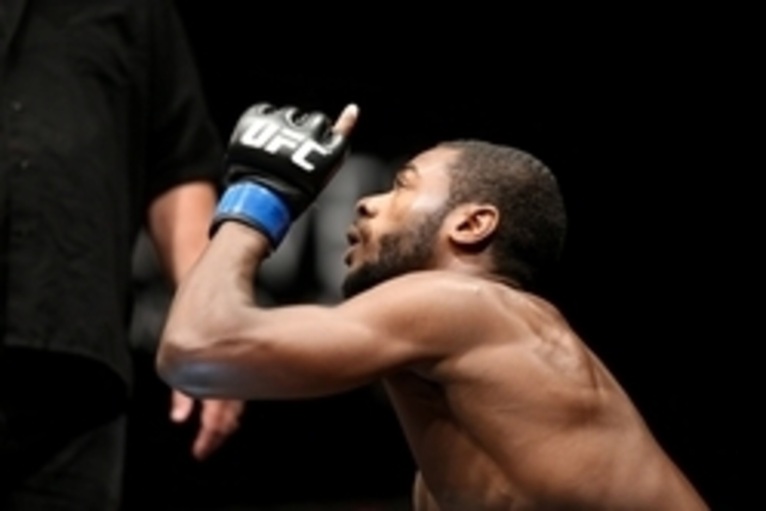 Jul 16, 2014; Atlantic City, NJ, USA; Aljamain Sterling (blue gloves) points a finger up in the air during a bantamweight bout at Revel Casino. Mandatory Credit: Bill Streicher-USA TODAY Sports
