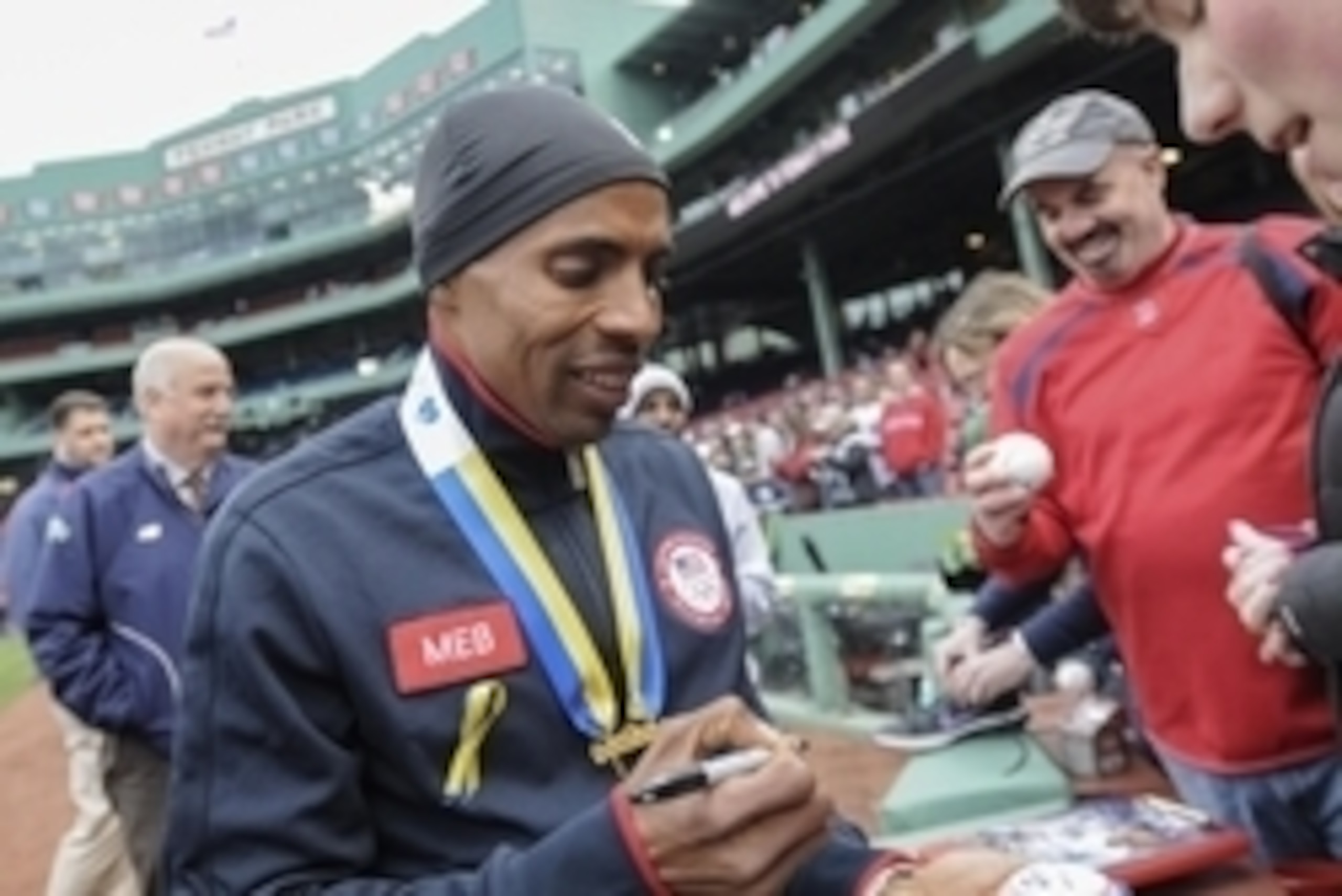 Apr 23, 2014; Boston, MA, USA; 2014 Boston Marathon winner Meb Keflezighi signs autographs prior to a game between the Boston Red Sox and New York Yankees at Fenway Park. Mandatory Credit: Bob DeChiara-USA TODAY Sports