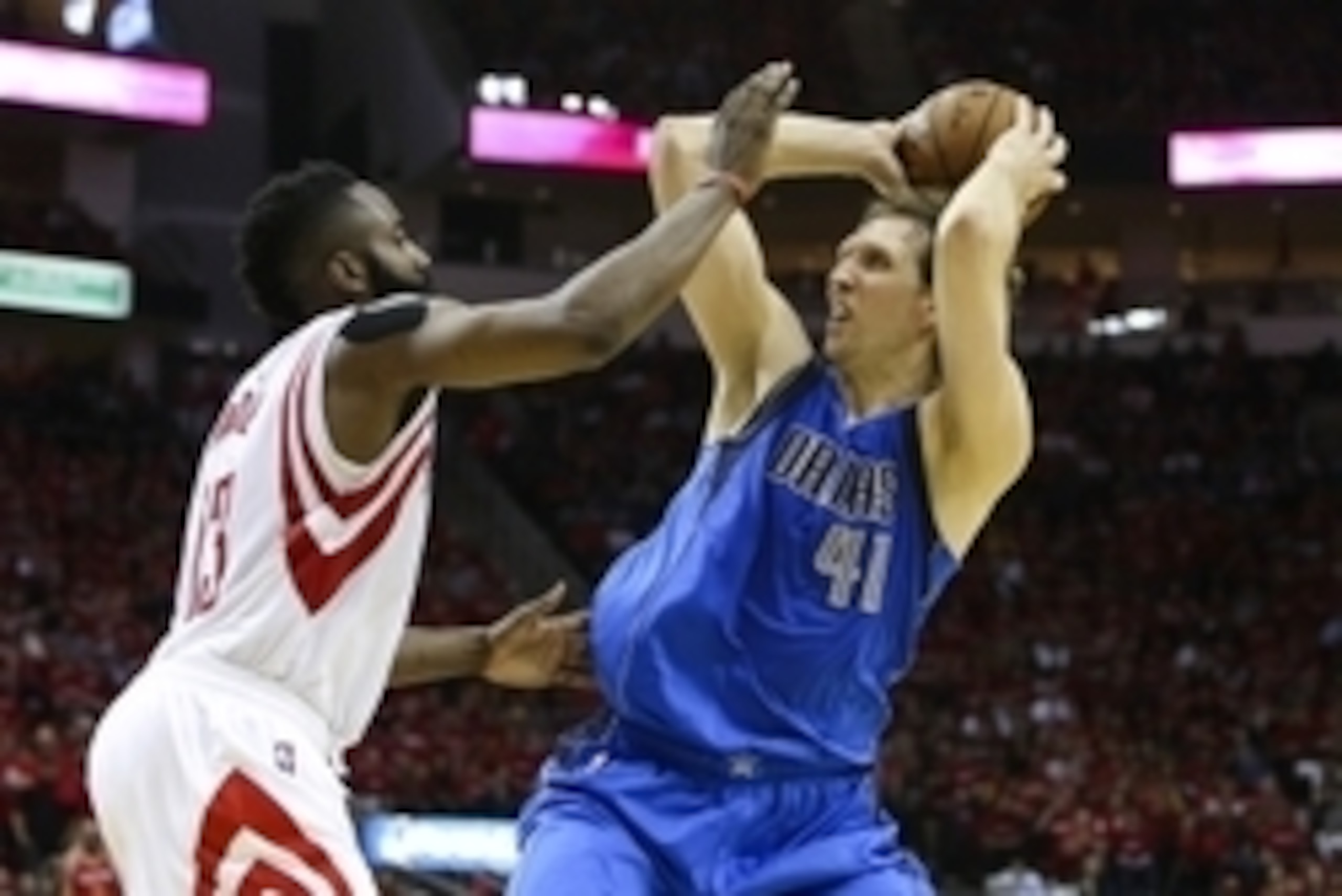 Apr 18, 2015; Houston, TX, USA; Dallas Mavericks forward Dirk Nowitzki (41) controls the ball as Houston Rockets guard James Harden (13) defends during the fourth quarter in game one of the first round of the NBA Playoffs at Toyota Center. The Rockets def