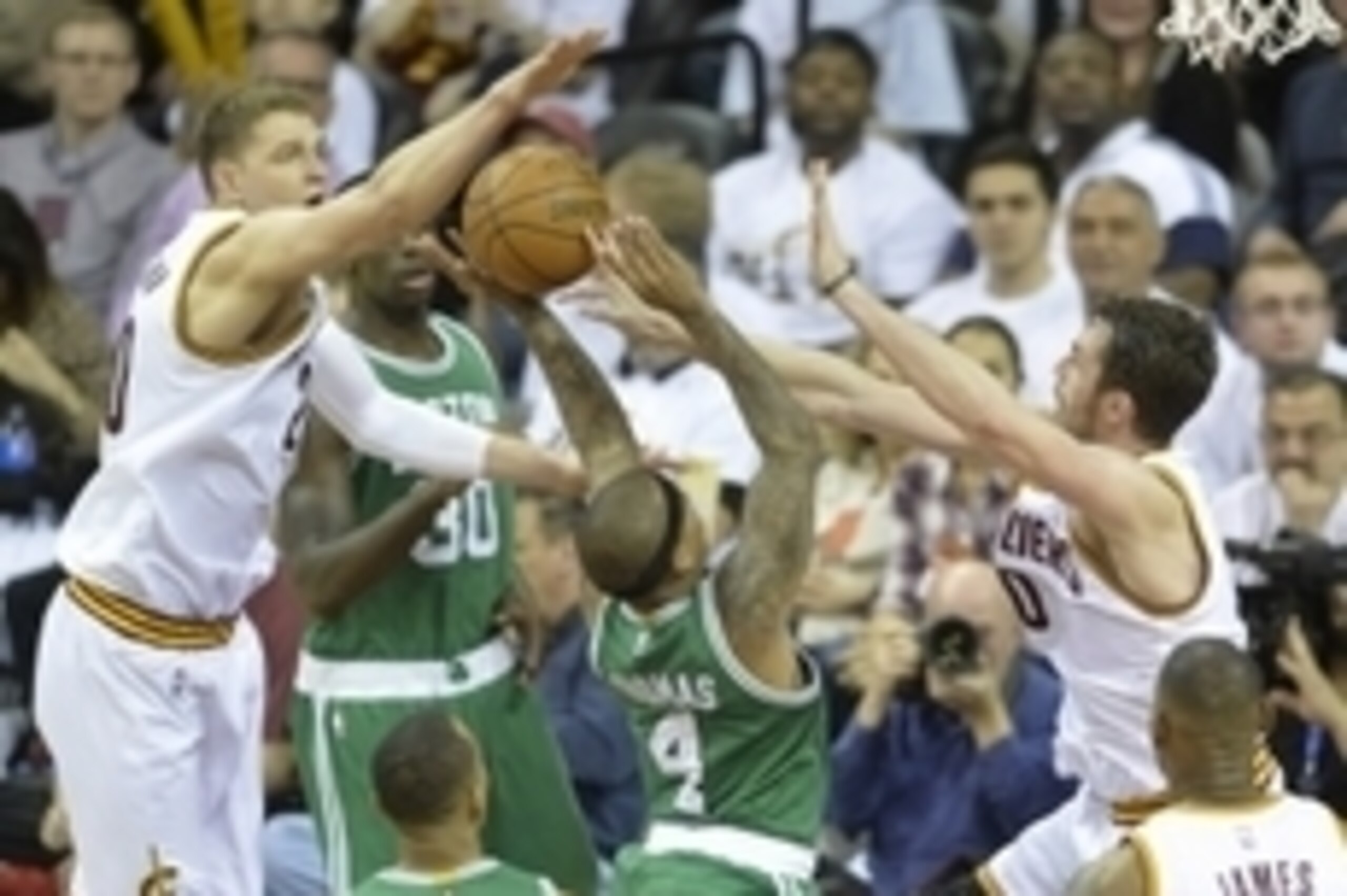 Apr 19, 2015; Cleveland, OH, USA; Boston Celtics guard Isaiah Thomas (4) drives between Cleveland Cavaliers center Timofey Mozgov (20) and forward Kevin Love (0) in the third quarter in game one of the first round of the NBA Playoffs at Quicken Loans Aren