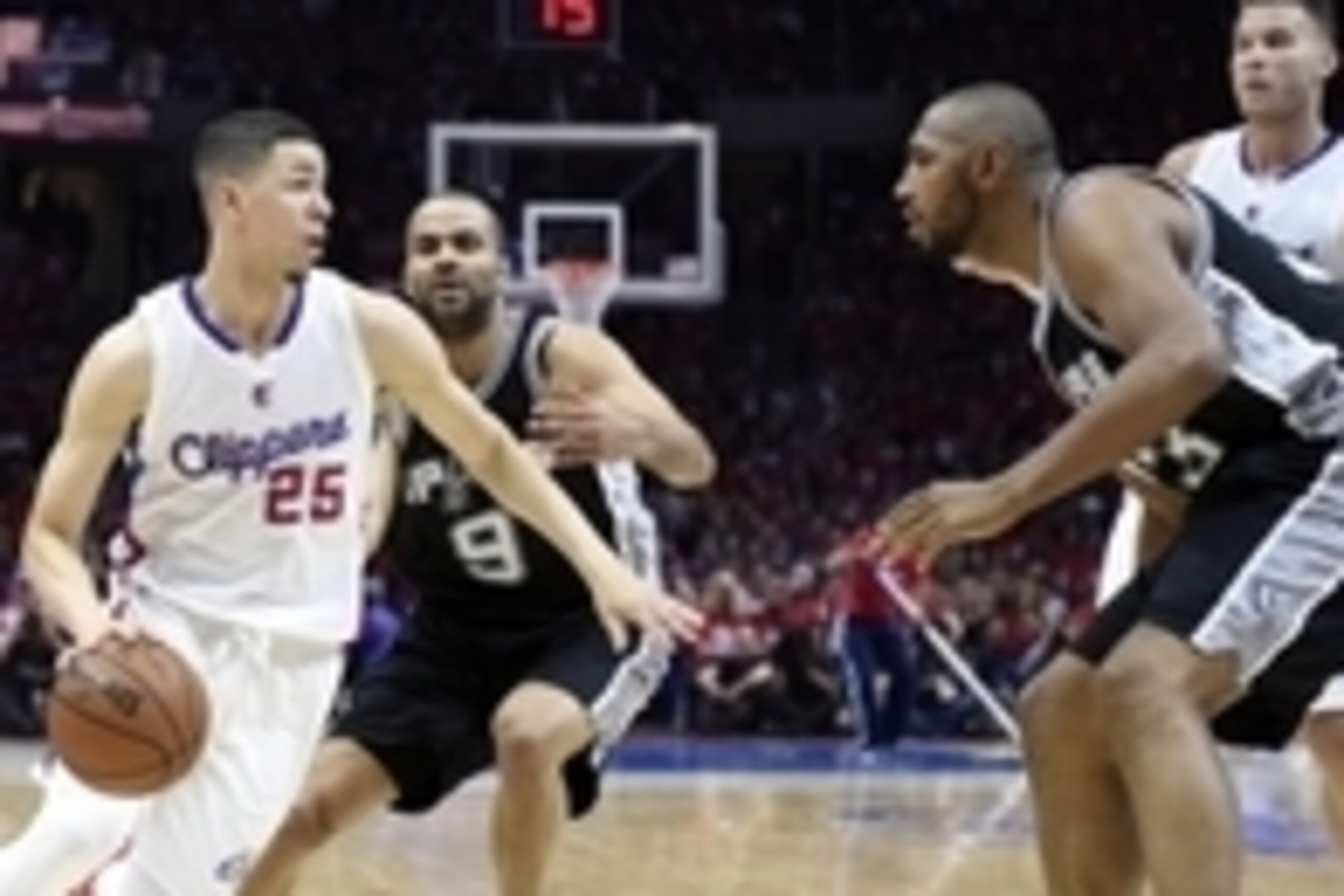 Apr 19, 2015; Los Angeles, CA, USA; Los Angeles Clippers guard Austin Rivers (25) drives to the basket against San Antonio Spurs guard Tony Parker (9) and center Boris Diaw (33) during the second quarter in game one of the first round of the NBA Playoffs 