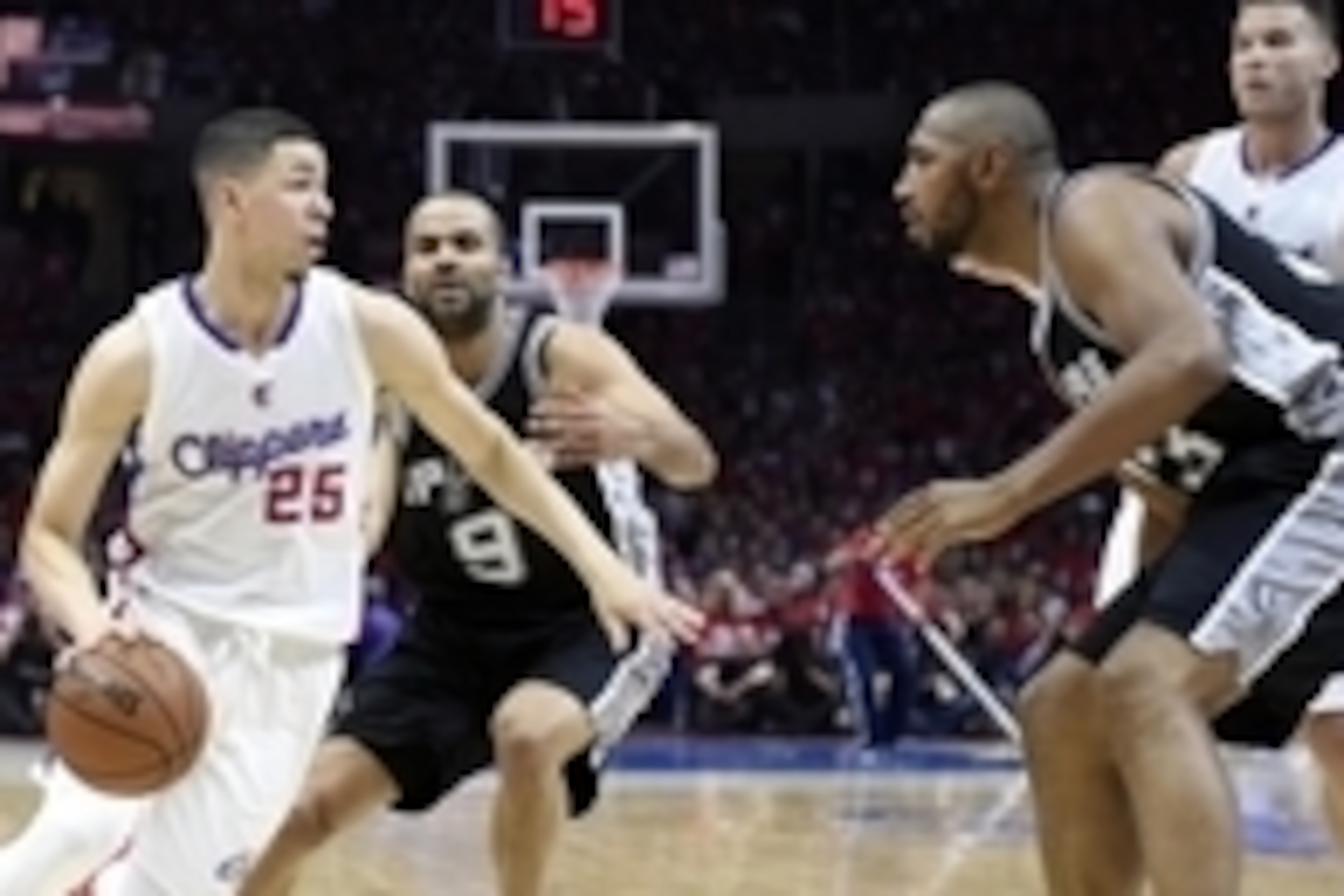 Apr 19, 2015; Los Angeles, CA, USA; Los Angeles Clippers guard Austin Rivers (25) drives to the basket against San Antonio Spurs guard Tony Parker (9) and center Boris Diaw (33) during the second quarter in game one of the first round of the NBA Playoffs 