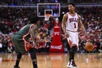 Apr 20, 2015; Chicago, IL, USA; Chicago Bulls guard Derrick Rose (1) dribbles the ball against Milwaukee Bucks guard O.J. Mayo (00) during the second half in game two of the first round of the 2015 NBA Playoffs at the United Center. The Chicago Bulls defe