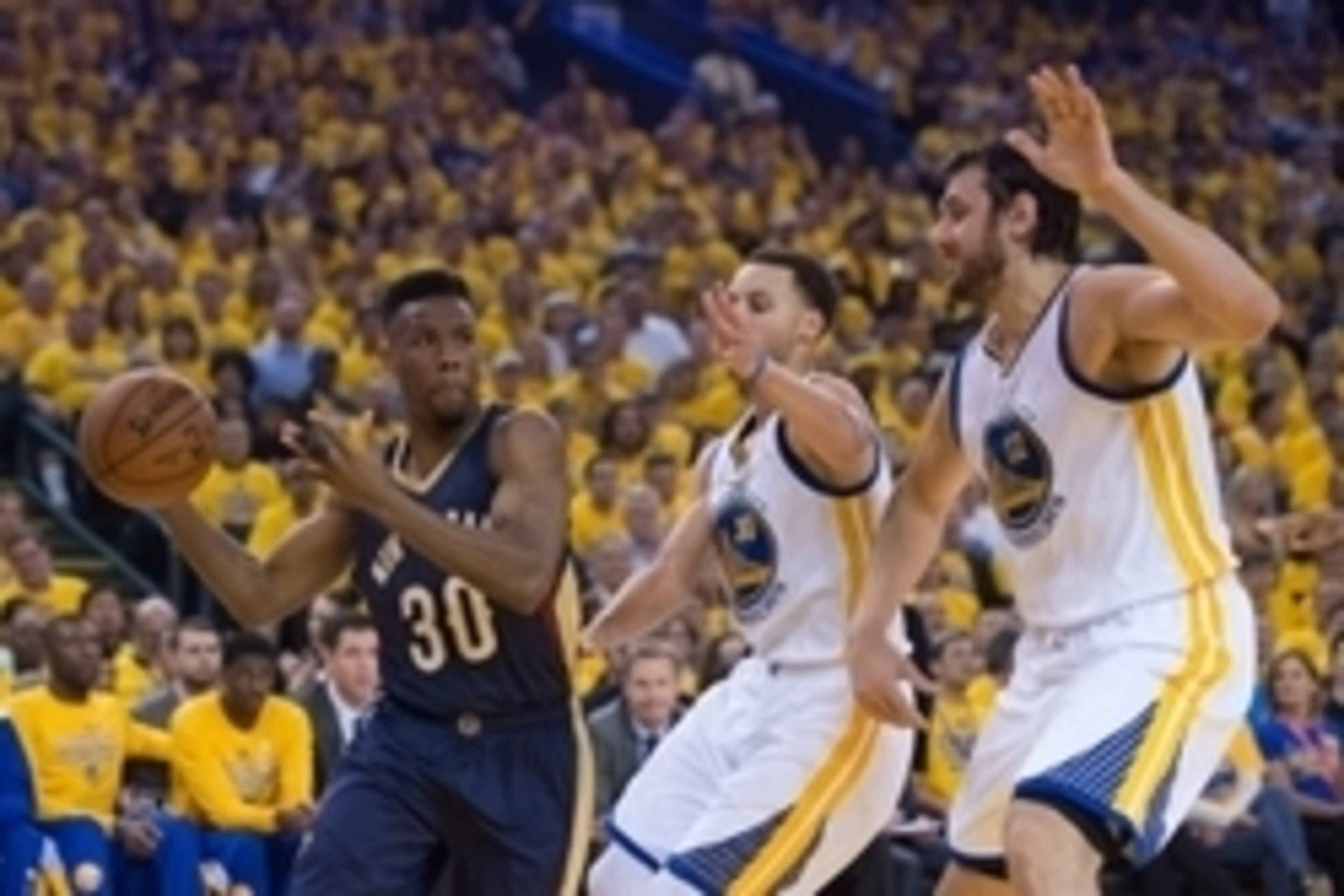 April 20, 2015; Oakland, CA, USA; New Orleans Pelicans guard Norris Cole (30) passes the basketball against Golden State Warriors guard Stephen Curry (30) and center Andrew Bogut (12) during the first quarter in game two of the first round of the NBA Play