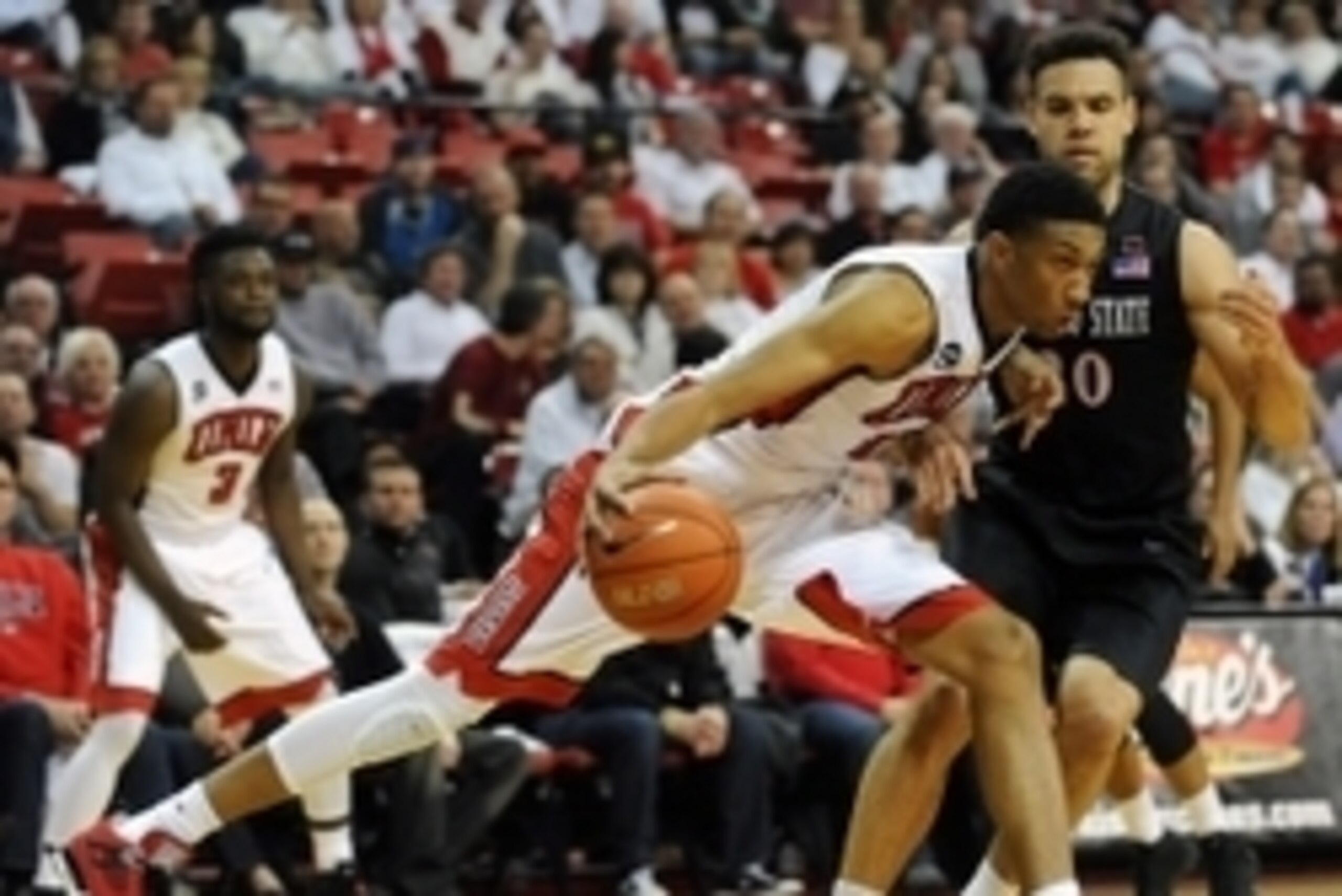 Mar 4, 2015; Las Vegas, NV, USA; UNLV Runnin' Rebels forward Christian Wood (5) dribbles the ball against the defense of San Diego Aztecs forward J.J. O'Brien (20) during a game at Thomas & Mack Center. The Aztecs defeated UNLV 60-58. Mandatory Credit: St