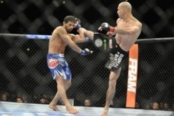 Jan 25, 2014; Chicago, IL, USA; Donald Cerrone (red gloves) fights Adriano Martins (blue gloves) during UFC on FOX 10 at the United Center. Mandatory Credit: David Banks-USA TODAY Sports