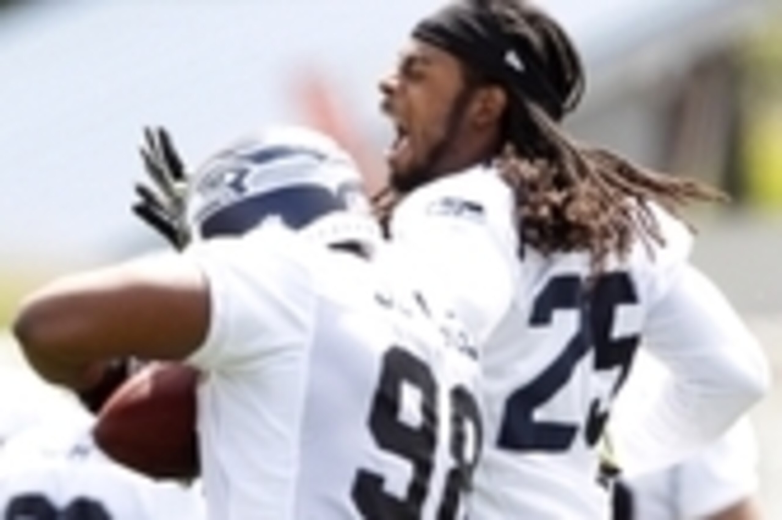 May 27, 2014; Renton, WA, USA; Seattle Seahawks defensive end Greg Scruggs (98) is greeted by cornerback Richard Sherman (25) following an interception by Scruggs during organized team activities at the Virginia Mason Athletic Center. Mandatory Credit: Jo