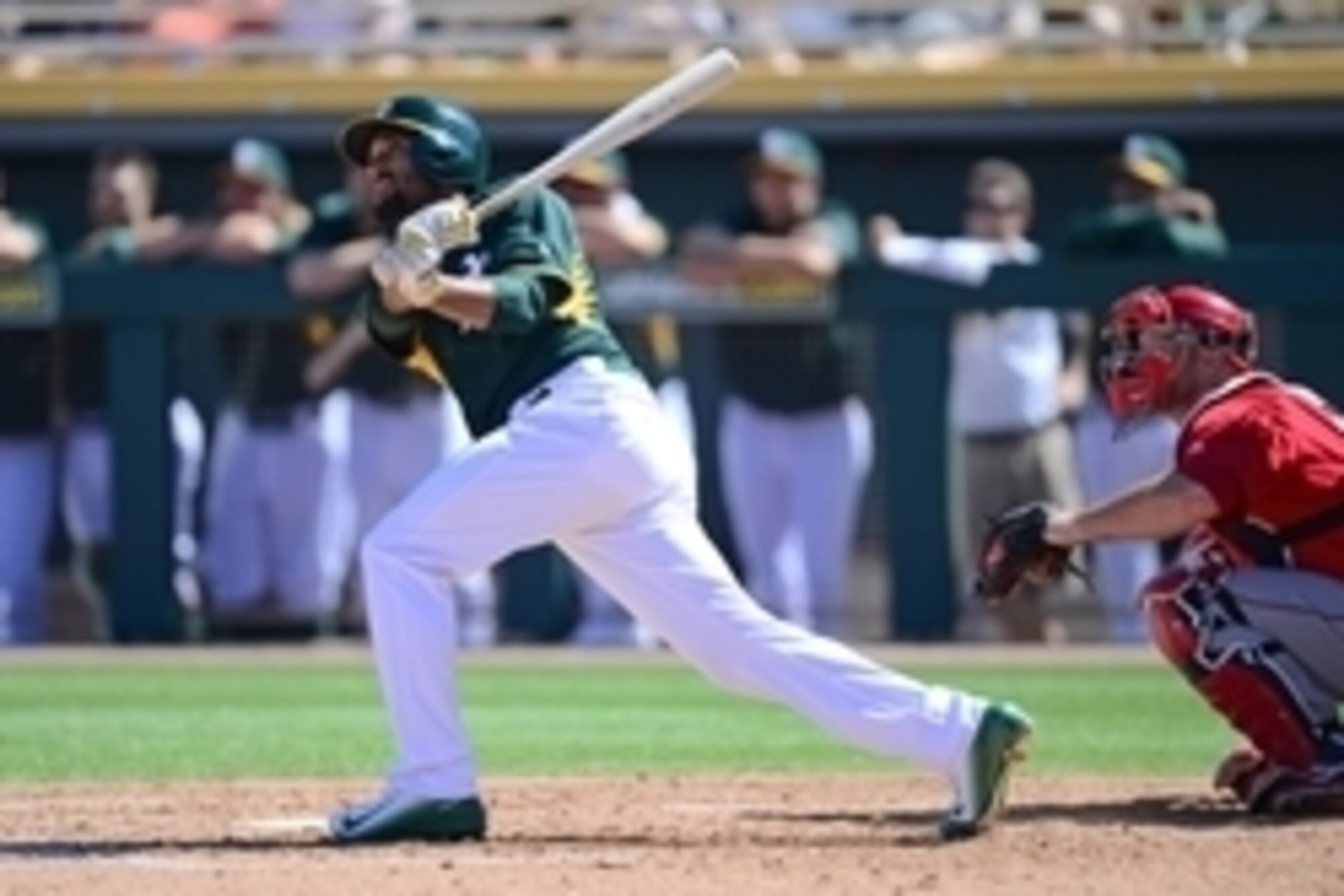 Mar 7, 2015; Mesa, AZ, USA; Oakland Athletics third baseman Marcus Semien (10) follws through on a swing against the Los Angeles Angels during a spring training baseball game at HoHoKam Stadium. Mandatory Credit: Joe Camporeale-USA TODAY Sports