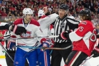 Apr 19, 2015; Ottawa, Ontario, CAN; Montreal Canadiens left wing Max Pacioretty (67) and Ottawa Senators defenseman Erik Karlsson (65) are separated by an official in game three of the first round of the 2015 Stanley Cup Playoffs at Canadian Tire Centre. 