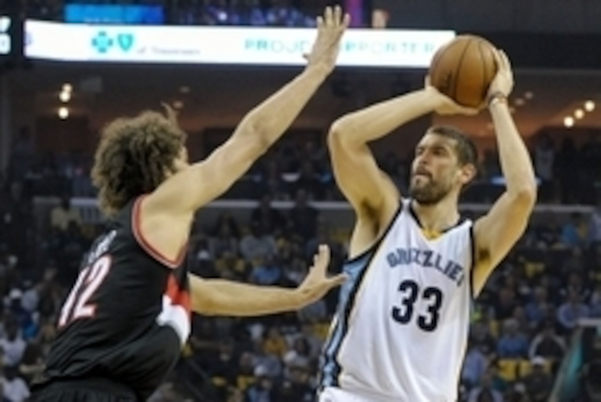 Apr 22, 2015; Memphis, TN, USA; Memphis Grizzlies center Marc Gasol (33) shoots over Portland Trail Blazers forward LaMarcus Aldridge (12) during game two of the first round of the NBA Playoffs at FedExForum. Mandatory Credit: Justin Ford-USA TODAY Sports