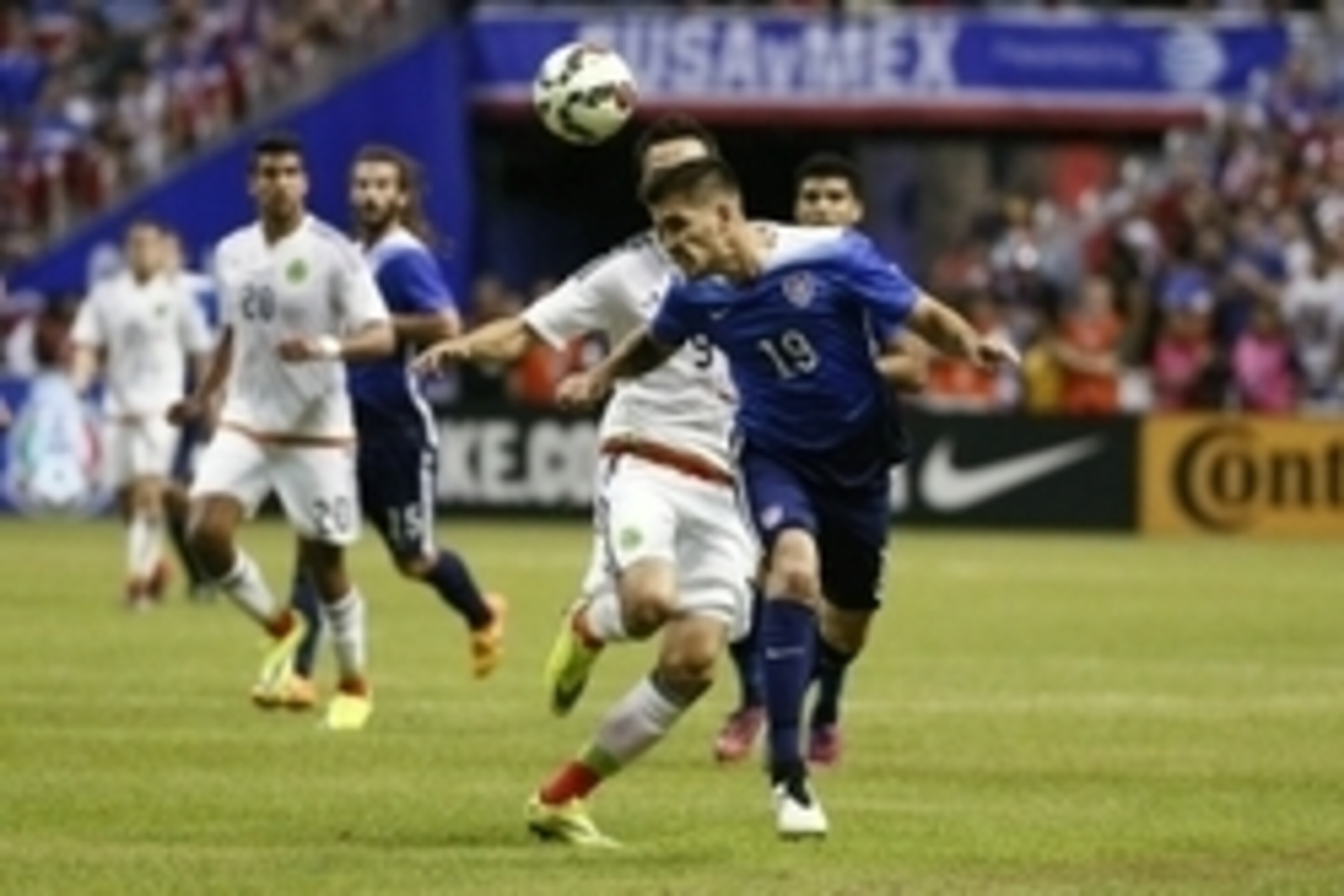 Apr 15, 2015; San Antonio, TX, USA; USA defender Ventura Alvarado (19) heads the ball while being defended by Mexico forward Erick Torres (9) during the first half at Alamodome. Mandatory Credit: Soobum Im-USA TODAY Sports