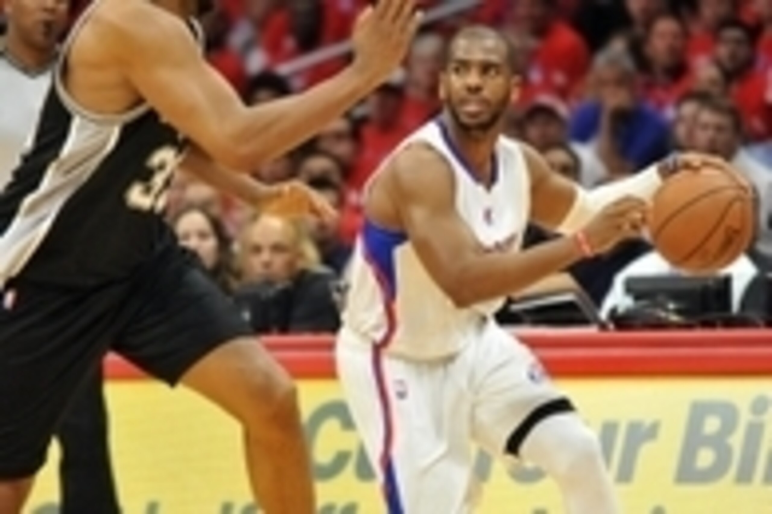 April 22, 2015; Los Angeles, CA, USA; Los Angeles Clippers guard Chris Paul (3) moves the ball against the defense of San Antonio Spurs center Boris Diaw (33) during the first half in game two of the first round of the NBA Playoffs. at Staples Center. Man