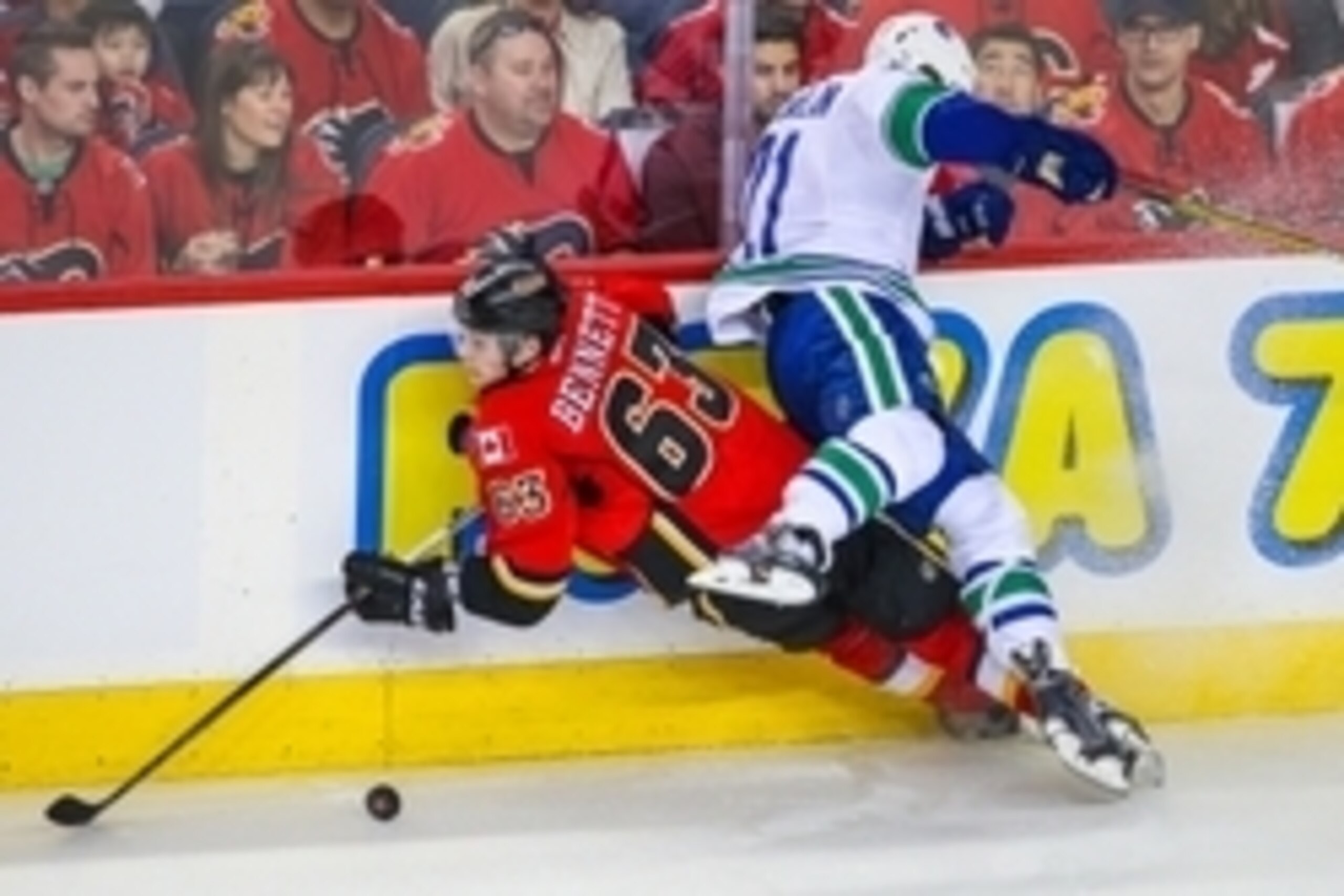 Apr 21, 2015; Calgary, Alberta, CAN; Calgary Flames center Sam Bennett (63) and Vancouver Canucks left wing Brandon McMillan (21) battle for the puck during the second period in game four of the first round of the 2015 Stanley Cup Playoffs at Scotiabank S Apr 21, 2015; Calgary, Alberta, CAN; Calgary Flames center Sam Bennett (63) and Vancouver Canucks left wing Brandon McMillan (21) battle for the puck during the second period in game four of the first round of the 2015 Stanley Cup Playoffs at Scotiabank S
