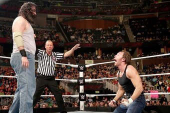 Luke Harper watches Dean Ambrose get riled up.