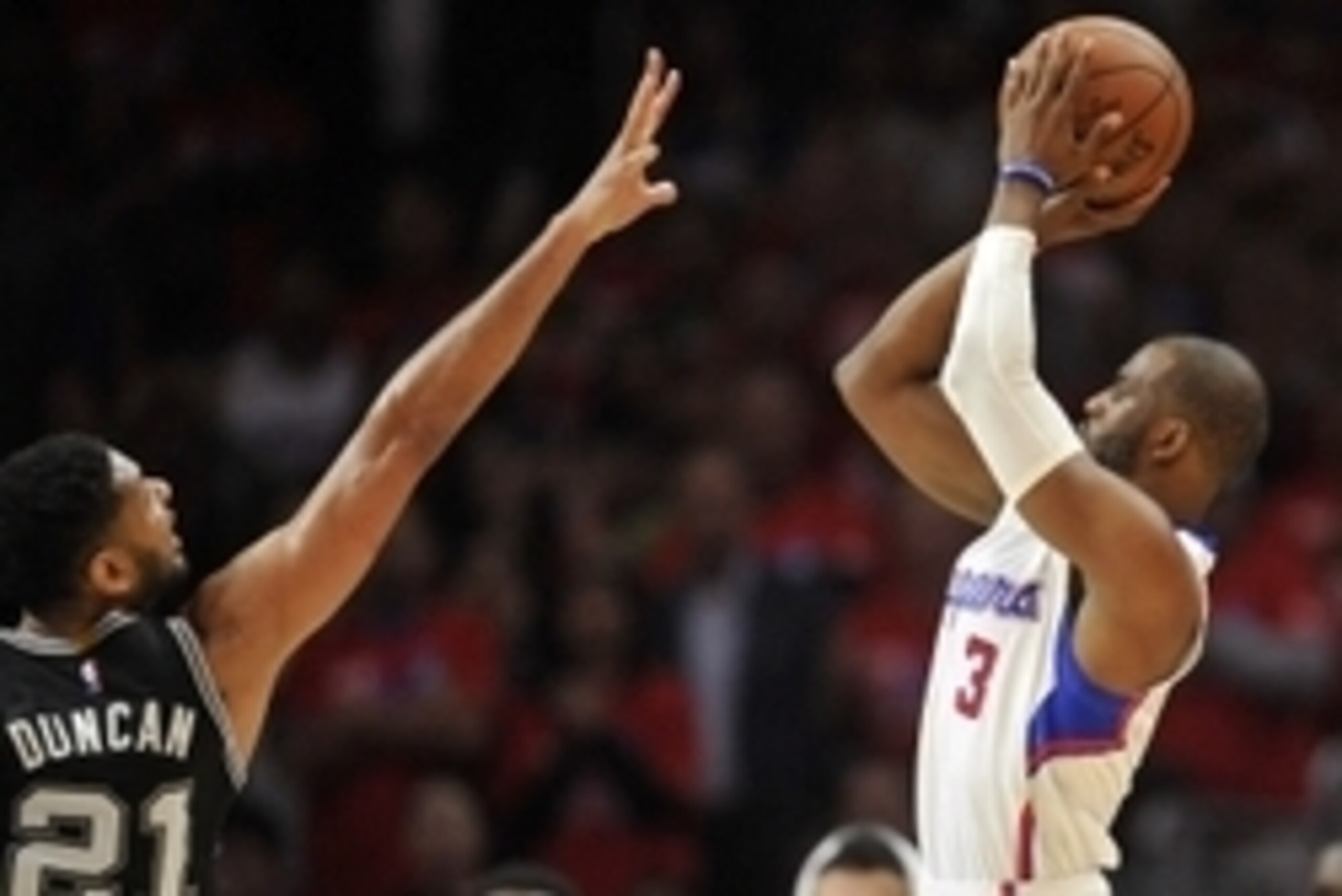 April 22, 2015; Los Angeles, CA, USA; Los Angeles Clippers guard Chris Paul (3) shoots against the defense of San Antonio Spurs forward Tim Duncan (21) during the second half in game two of the first round of the NBA Playoffs. at Staples Center. Mandatory