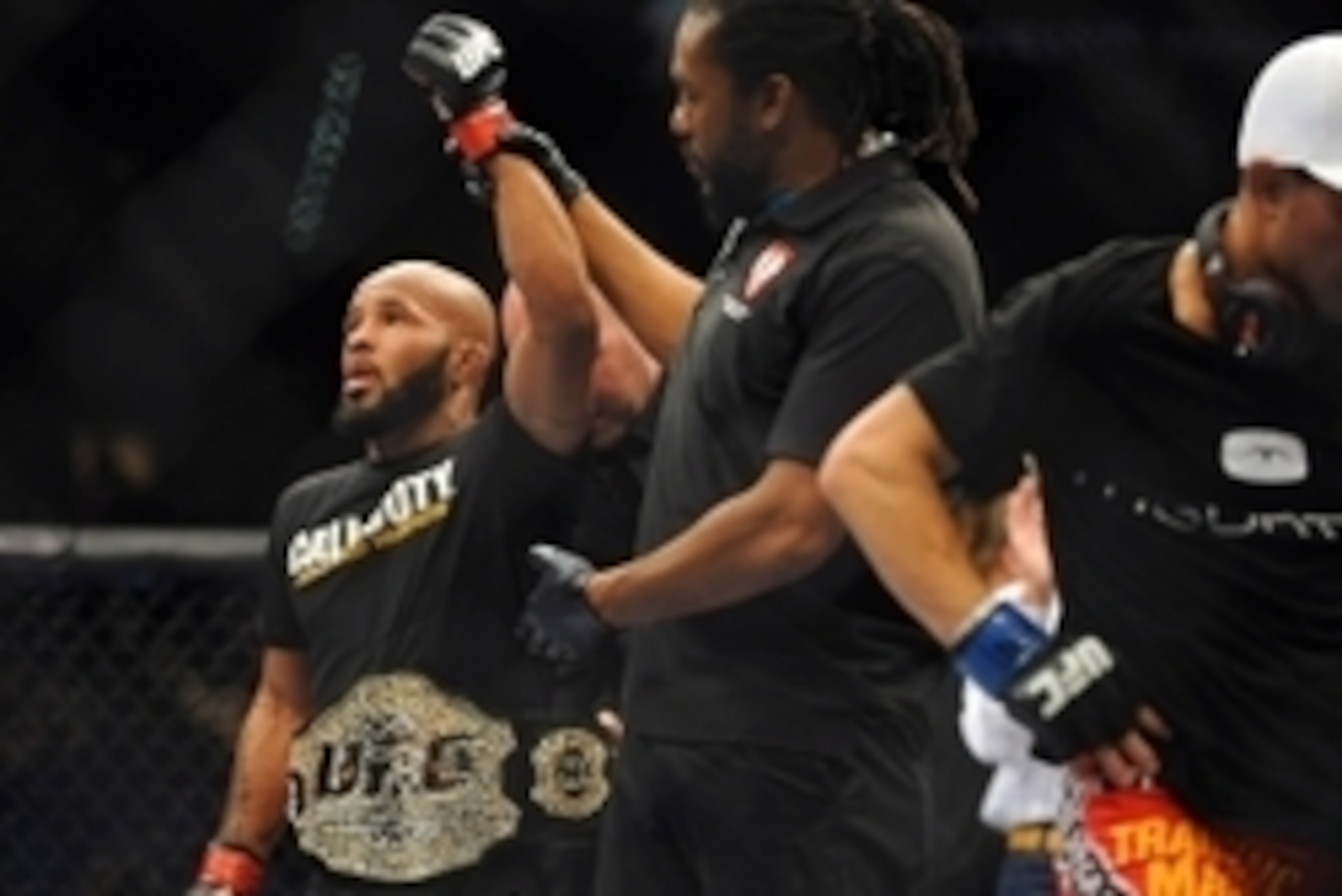 Sep 27, 2014; Las Vegas, NV, USA; Demetrious Johnson (red gloves) is declared the victor over Chris Cariaso (blue gloves) in a defense of his featherweight title during UFC 178 at MGM Grand Garden Arena. Mandatory Credit: Stephen R. Sylvanie-USA TODAY Spo