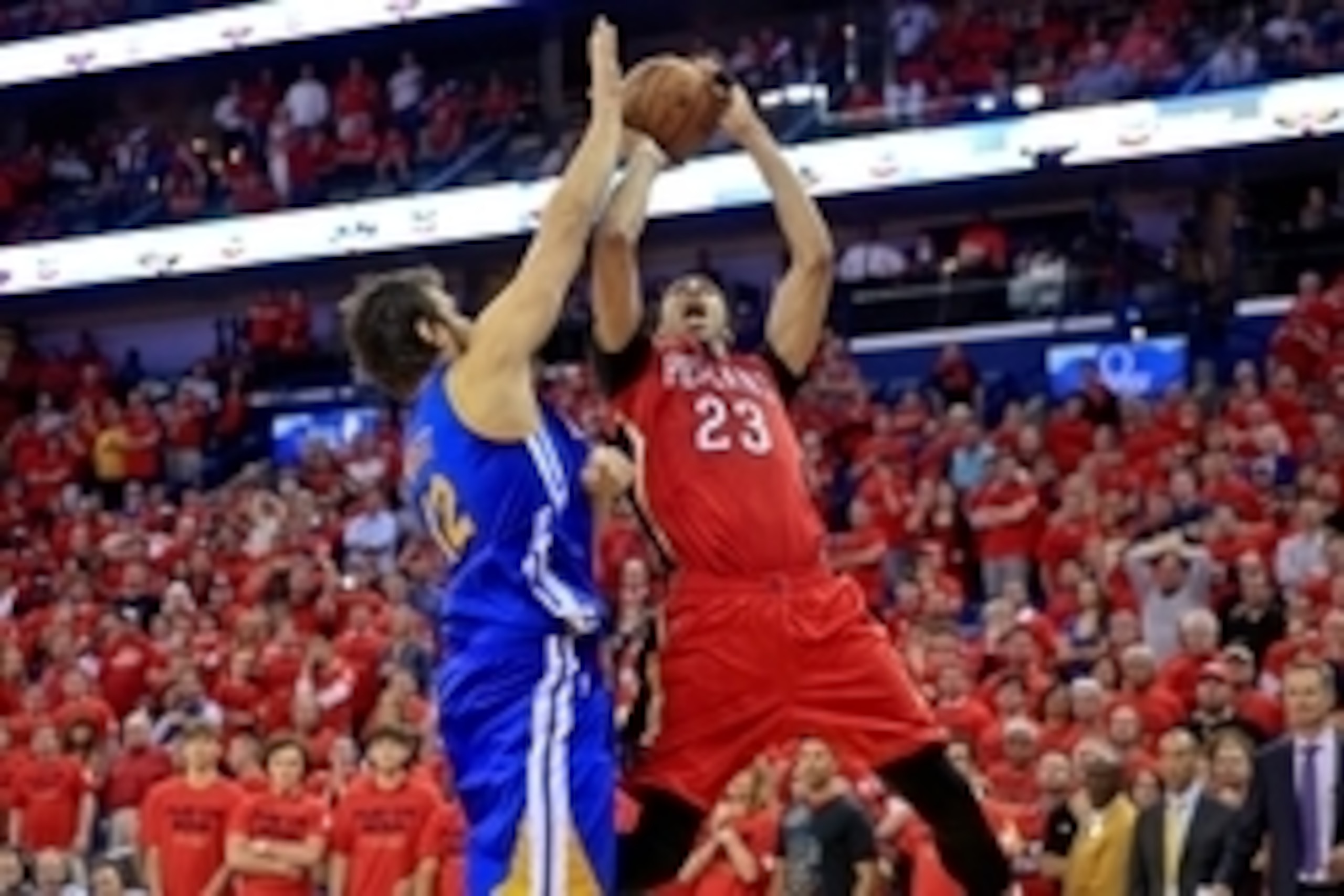 Apr 23, 2015; New Orleans, LA, USA; New Orleans Pelicans forward Anthony Davis (23) reacts as he shoots over Golden State Warriors center Andrew Bogut (12) in overtime in game three of the first round of the NBA Playoffs at  the Smoothie King Center. The 