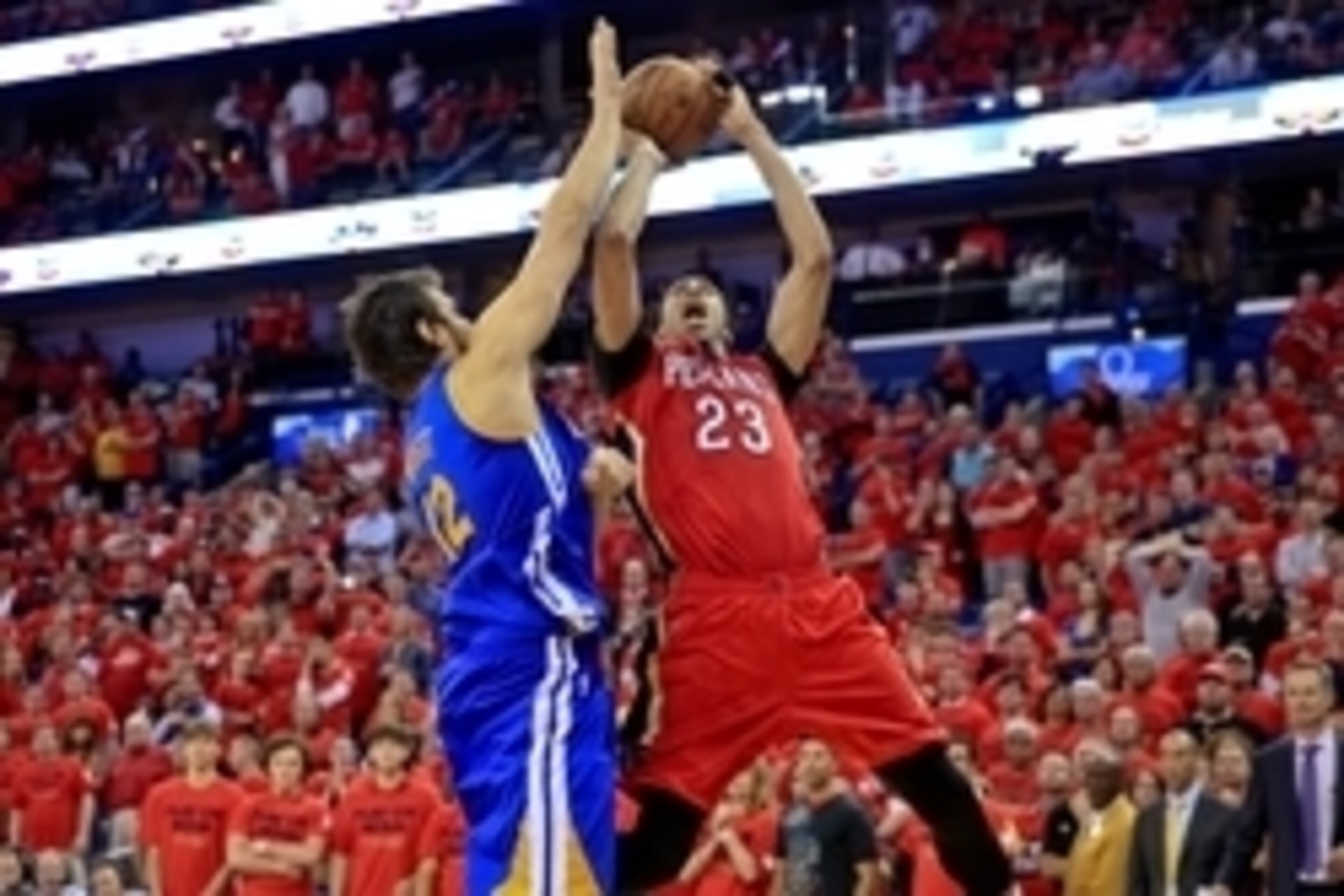 Apr 23, 2015; New Orleans, LA, USA; New Orleans Pelicans forward Anthony Davis (23) reacts as he shoots over Golden State Warriors center Andrew Bogut (12) in overtime in game three of the first round of the NBA Playoffs at  the Smoothie King Center. The 