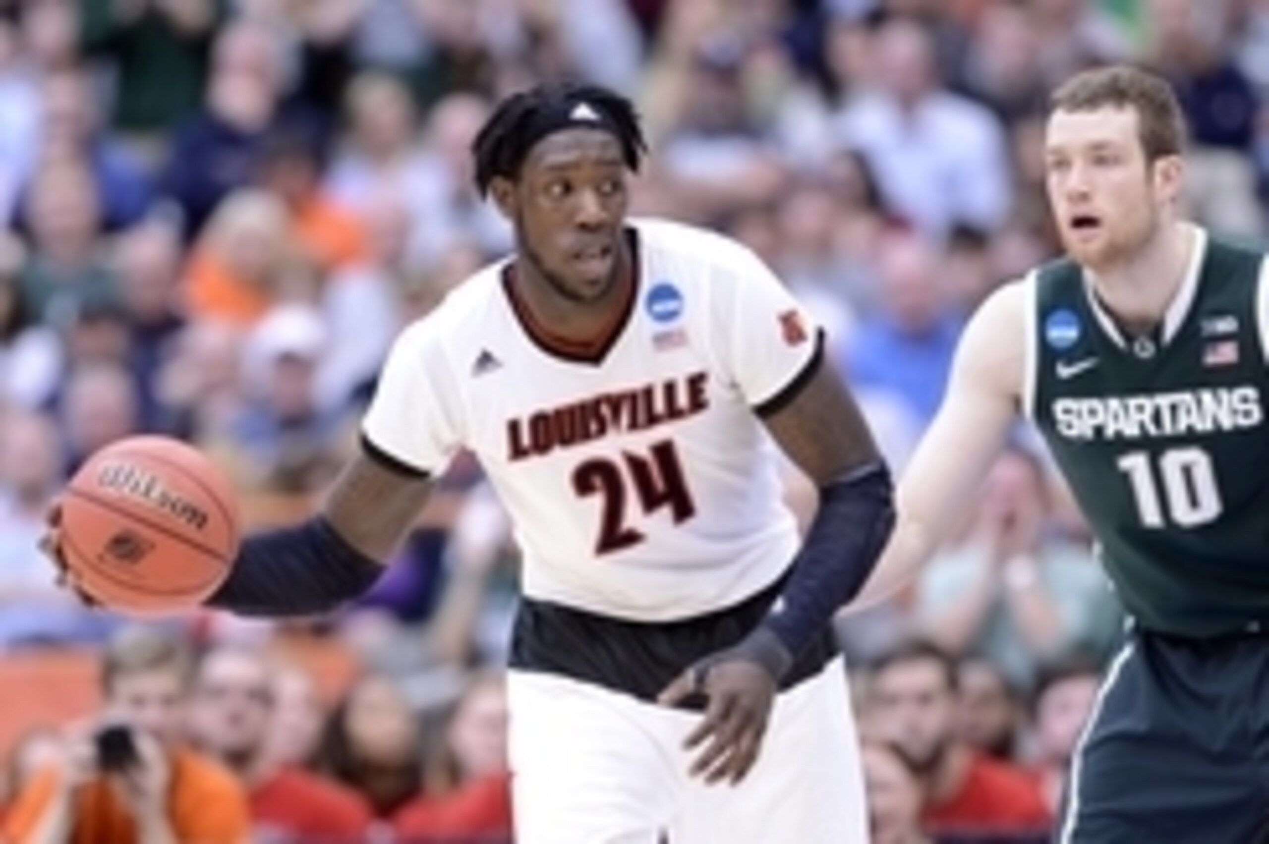 Mar 29, 2015; Syracuse, NY, USA; Louisville Cardinals forward Montrezl Harrell (24) handles the ball against Michigan State Spartans forward Matt Costello (10) during the second half in the finals of the east regional of the 2015 NCAA Tournament at Carrie Mar 29, 2015; Syracuse, NY, USA; Louisville Cardinals forward Montrezl Harrell (24) handles the ball against Michigan State Spartans forward Matt Costello (10) during the second half in the finals of the east regional of the 2015 NCAA Tournament at Carrie
