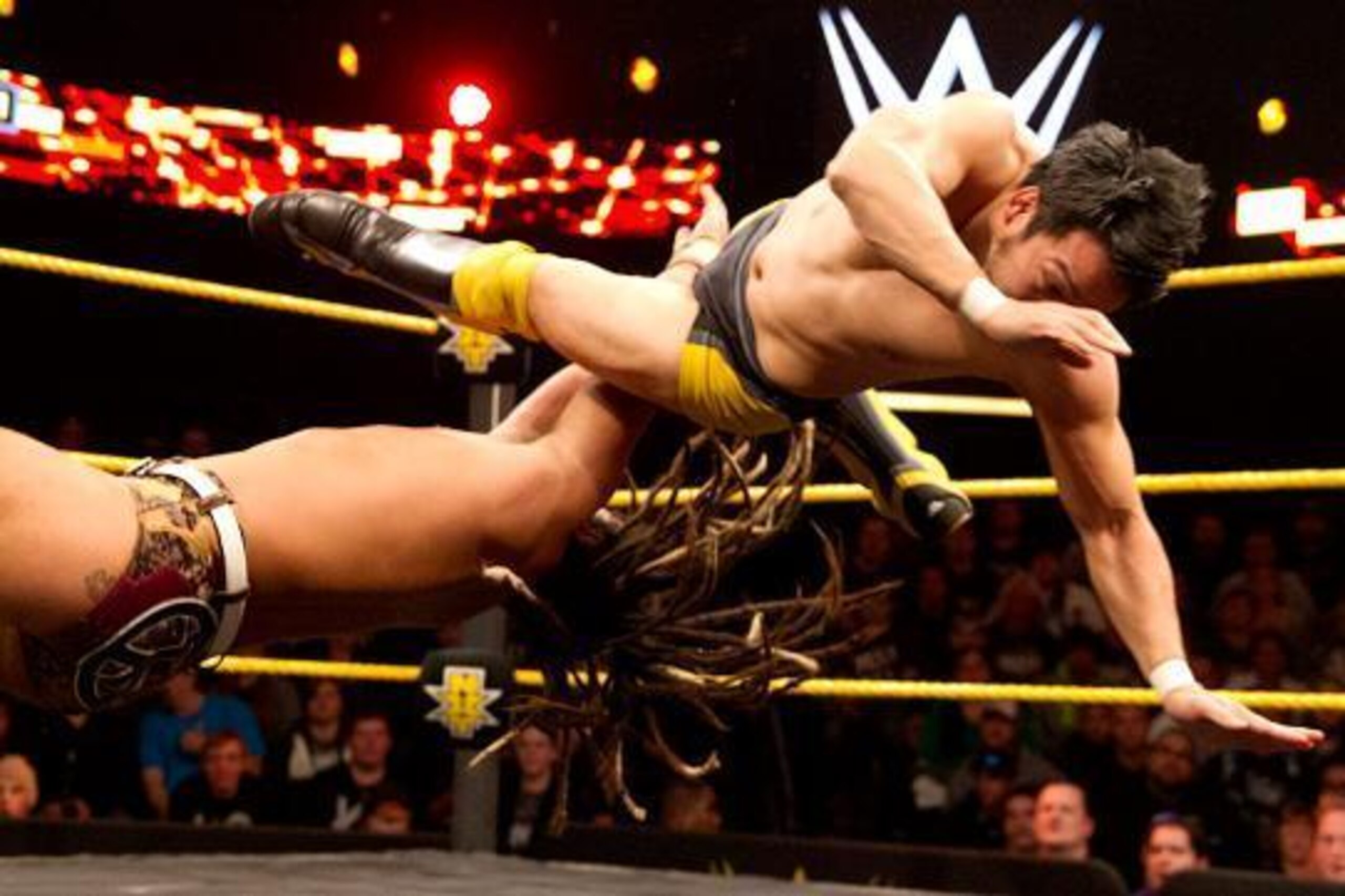 Hideo Itami knocks over CJ Parker.