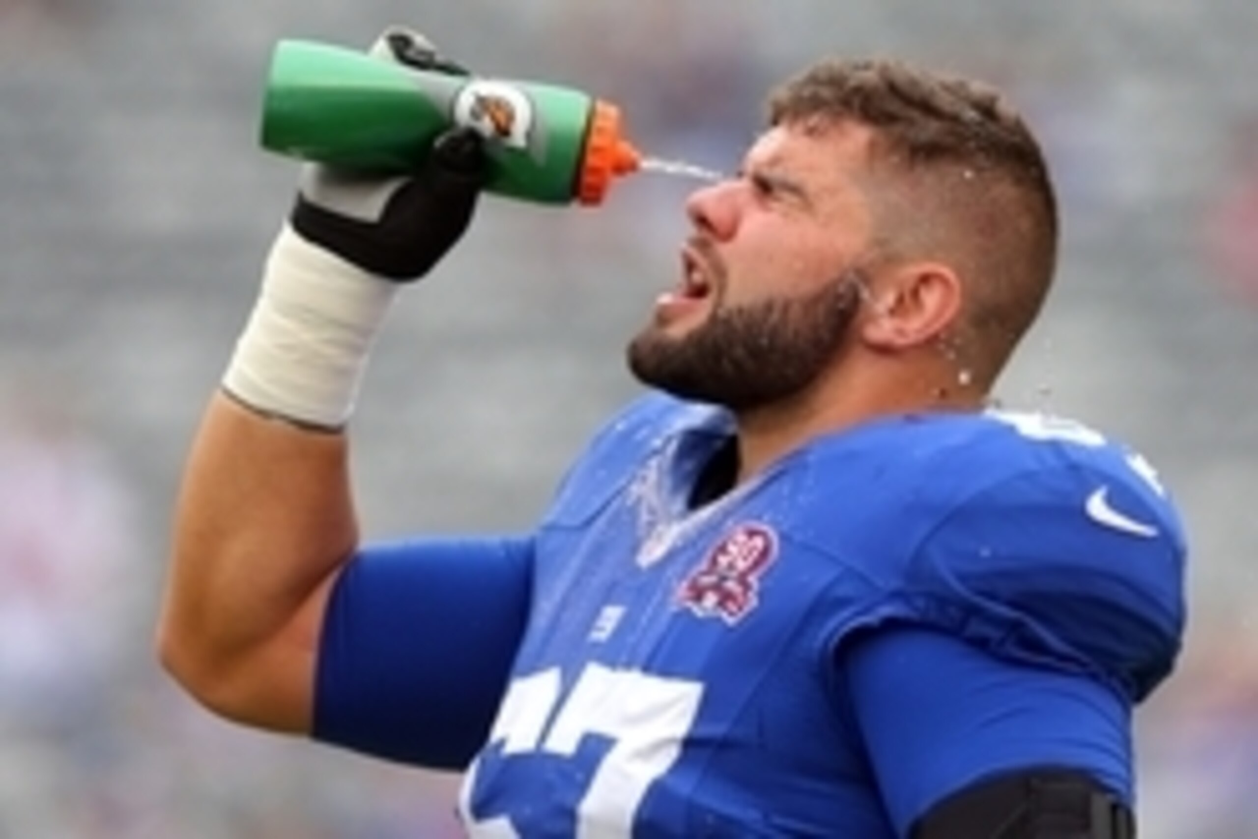 Sep 21, 2014; East Rutherford, NJ, USA; New York Giants offensive tackle Justin Pugh (67) squeezes water in his face during warmups before a game against the Houston Texans at MetLife Stadium. Mandatory Credit: Brad Penner-USA TODAY Sports
