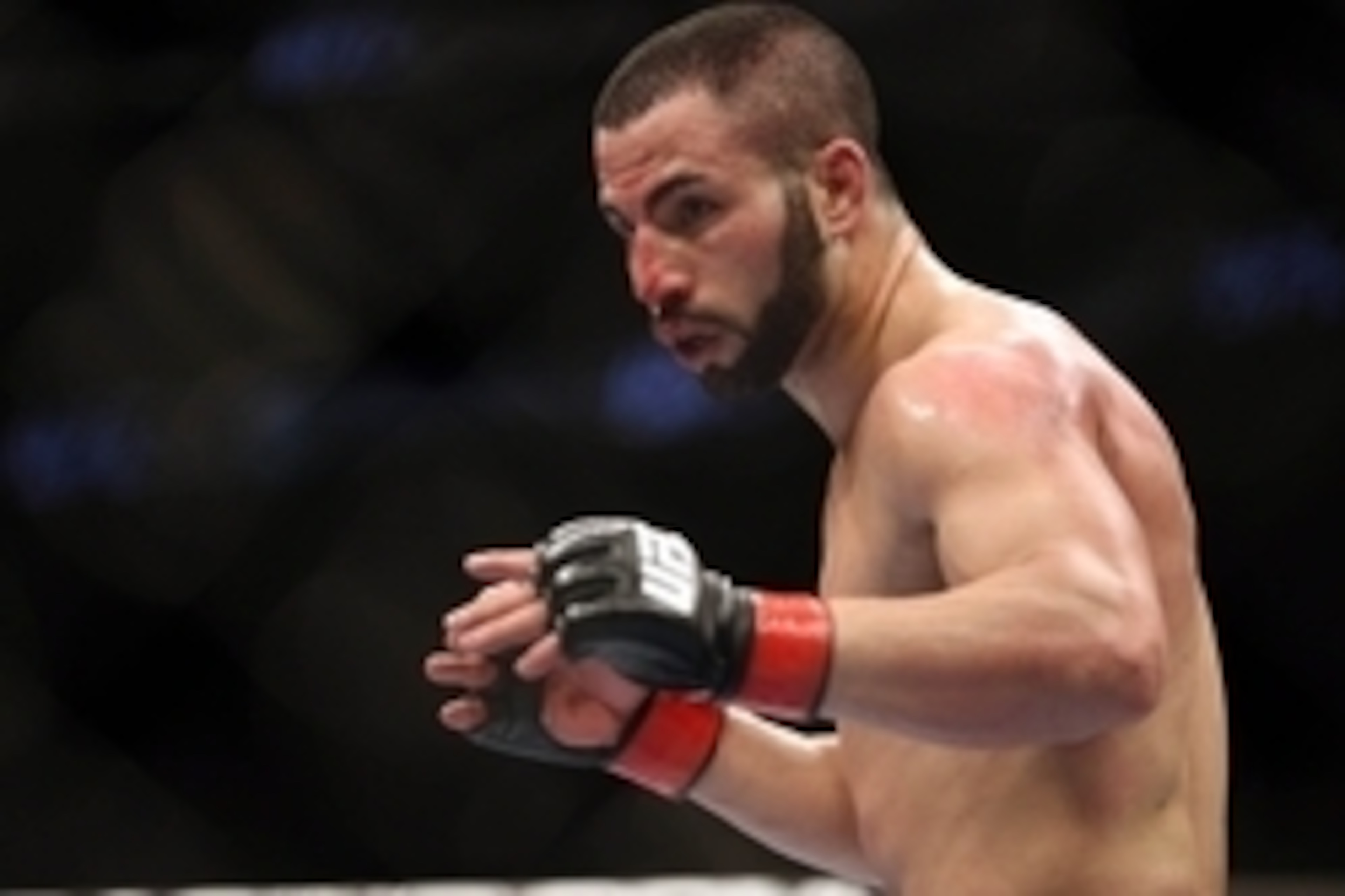 Feb 1, 2014; Newark, NJ, USA; John Makdessi (red gloves) bleeds from his head during his fight against Alan Patrick (not pictured) during UFC 169 at Prudential Center. Mandatory Credit: Joe Camporeale-USA TODAY Sports