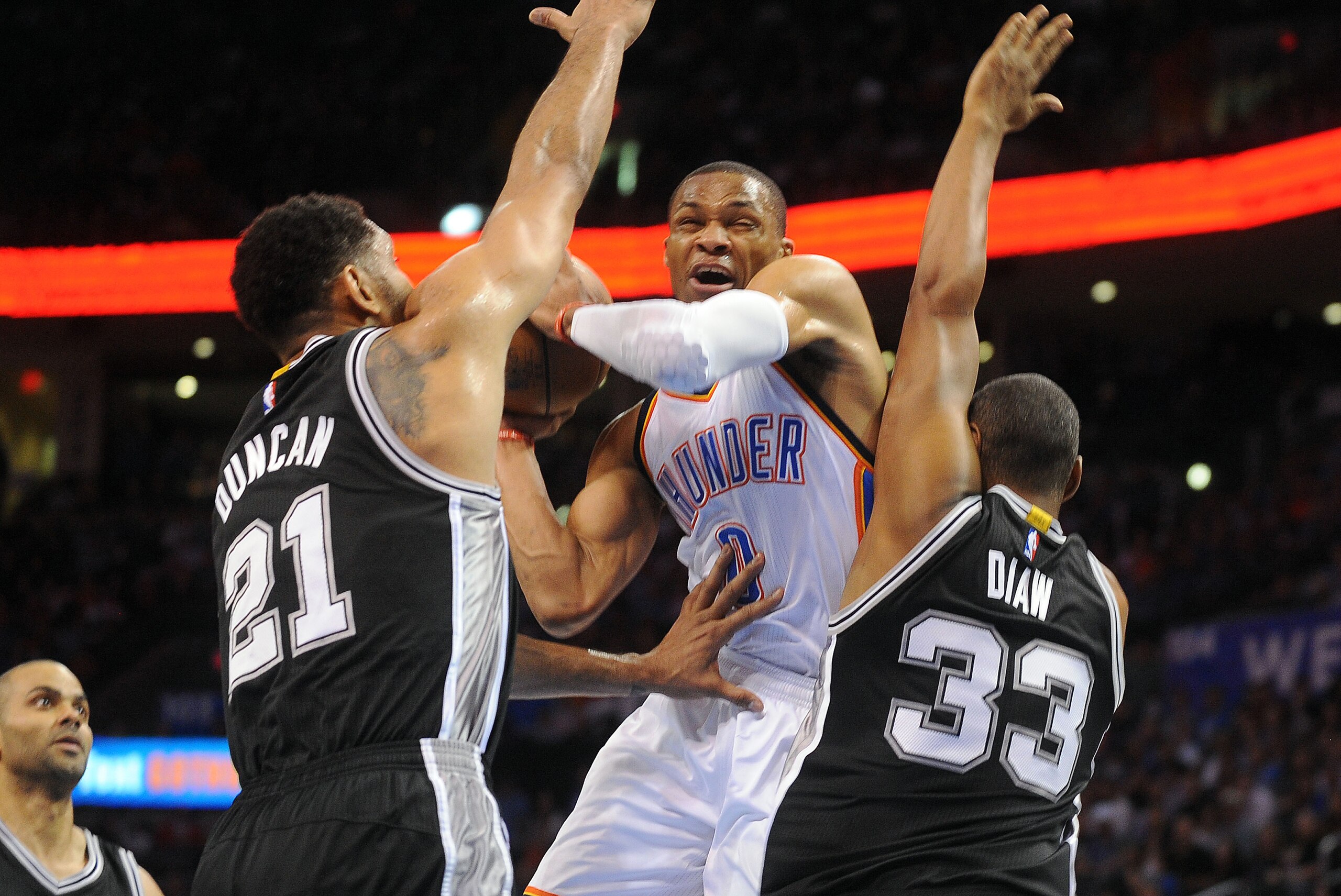 Apr 7, 2015; Oklahoma City, OK, USA; Oklahoma City Thunder guard Russell Westbrook (0) shoots the ball against San Antonio Spurs forward Tim Duncan (21) and center Boris Diaw (33) during the first quarter at Chesapeake Energy Arena. Mandatory Credit: Mark
