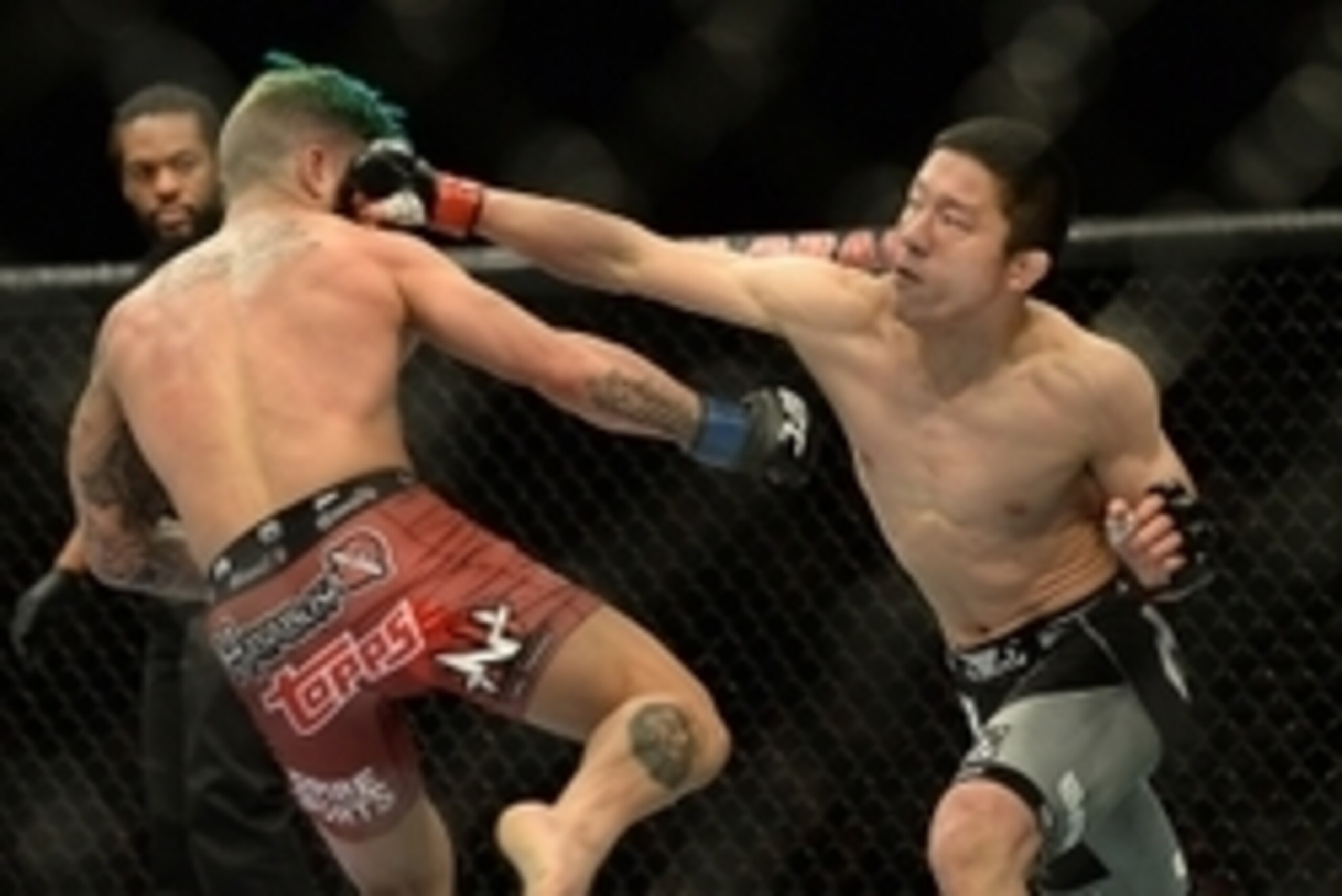 Jan 3, 2015; Las Vegas, NV, USA; Kyoji Horiguchi (red gloves) and Louis Gaudinot (blue gloves) compete in their flyweight bout at UFC 182 at MGM Grand Garden Arena. Mandatory Credit: Jayne Kamin-Oncea-USA TODAY Sports
