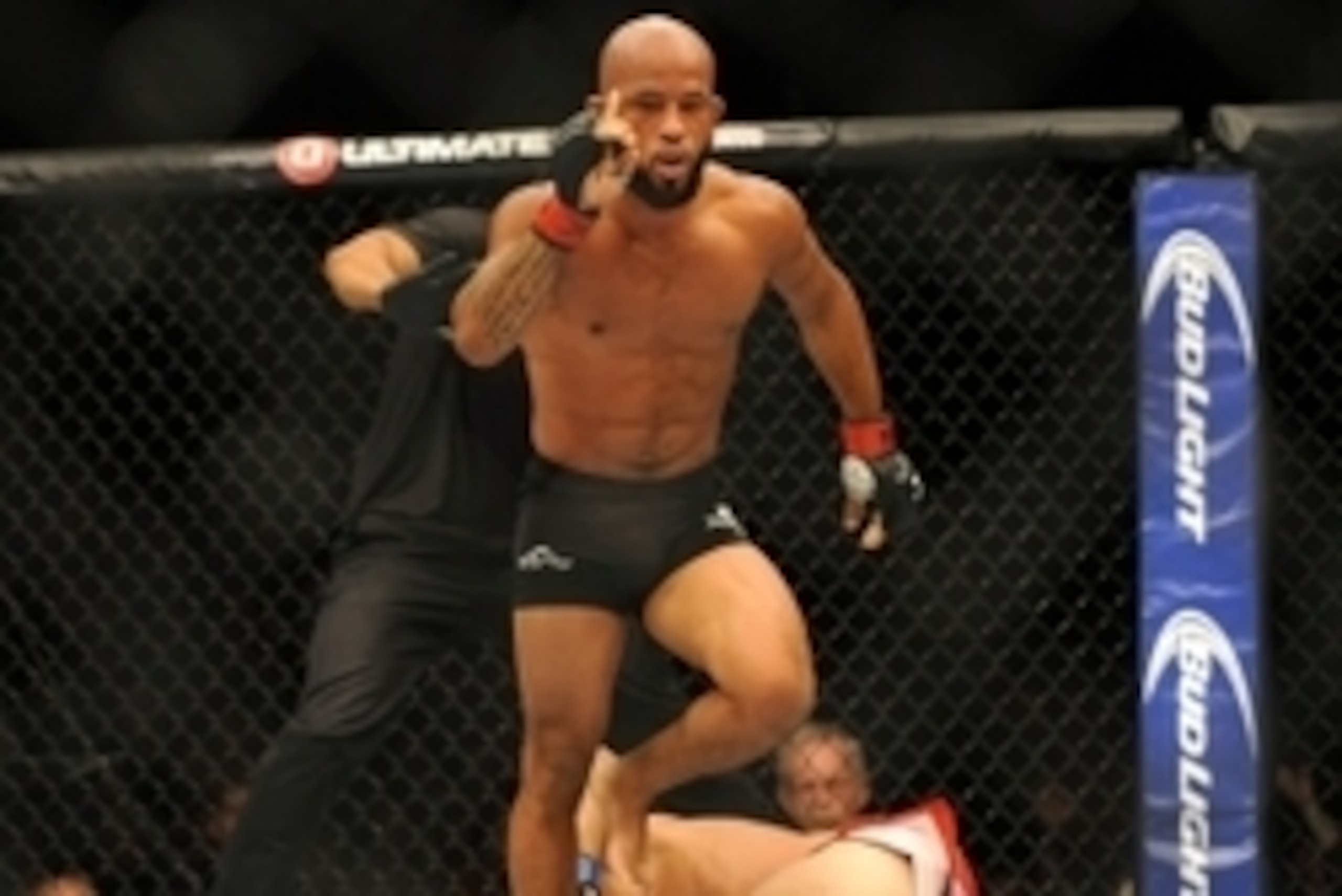 Sep 27, 2014; Las Vegas, NV, USA; Demetrious Johnson (red gloves) celebrates after referee Herb Brooks stops a featherweight title bout against Chris Cariaso (blue gloves) during UFC 178 at MGM Grand Garden Arena. Mandatory Credit: Stephen R. Sylvanie-USA