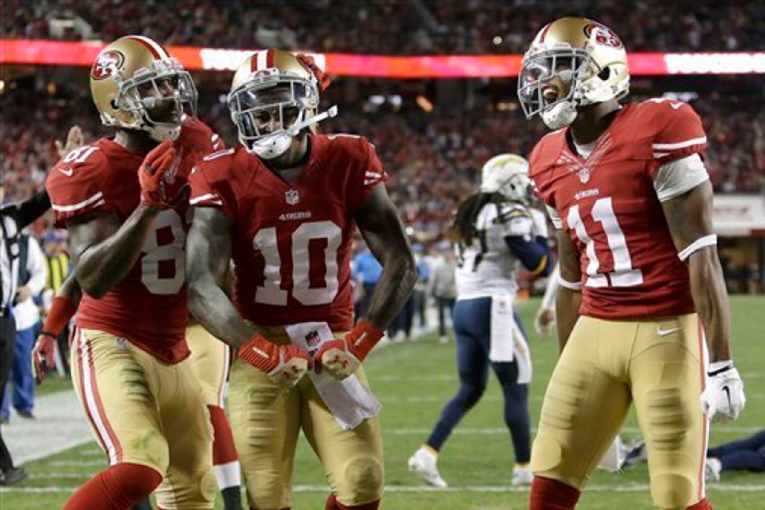 Anquan Boldin (No. 81) and Quinton Patton (No. 11) surround rookie Bruce Ellington (No. 10) after he scores one of his two touchdowns against the San Diego Chargers. Anquan Boldin (No. 81) and Quinton Patton (No. 11) surround rookie Bruce Ellington (No. 10) after he scores one of his two touchdowns against the San Diego Chargers.