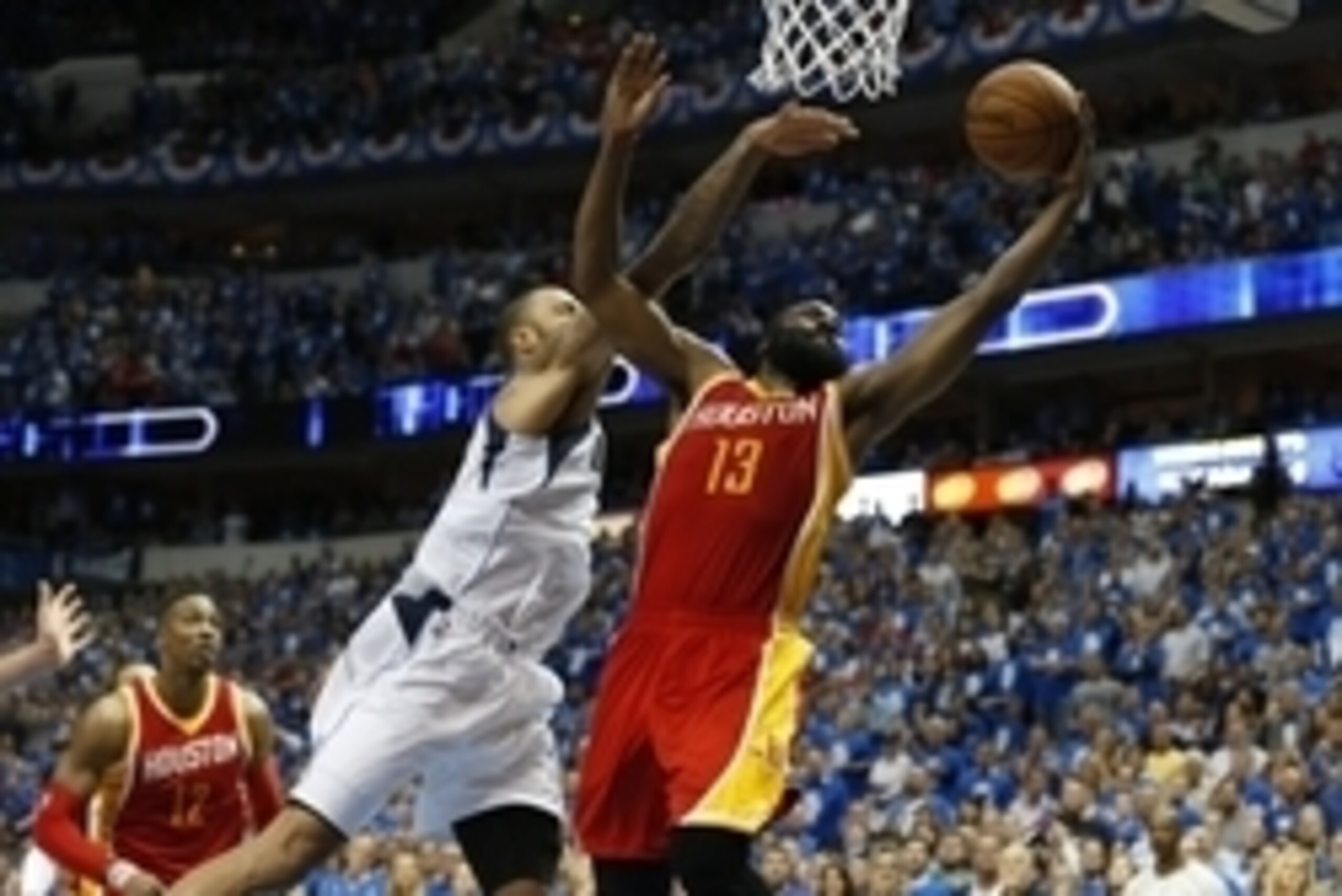 Apr 24, 2015; Dallas, TX, USA; Houston Rockets guard James Harden (13) shoots late in the fourth quarter while getting fouled by Dallas Mavericks center Tyson Chandler (6) in game three of the first round of the NBA Playoffs at American Airlines Center. T
