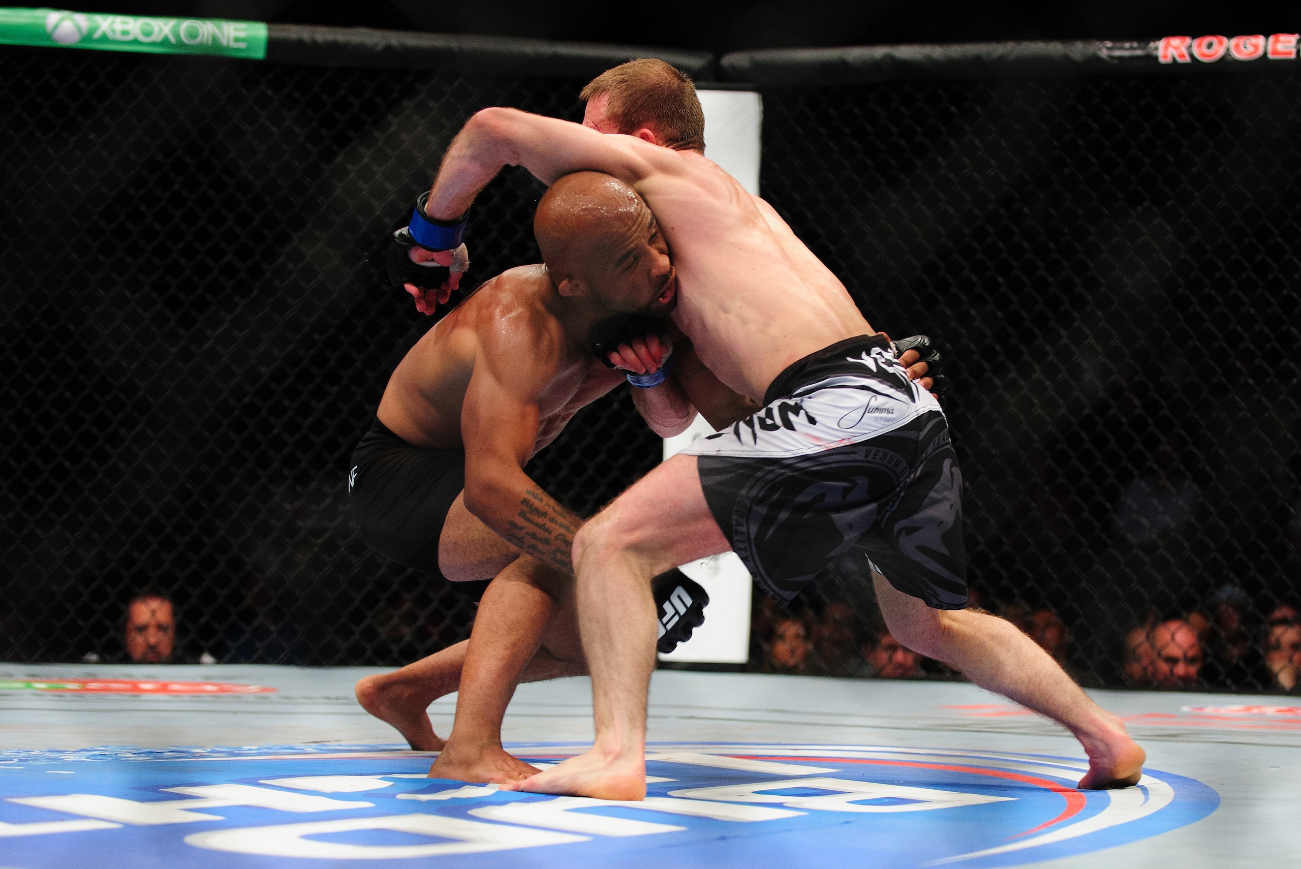 Jun 14, 2014; Vancouver, British Columbia, Canada; Demetrious Johnson (red) fights Ali Bagautinov (blue) in the Flyweight Title bout at UFC 174 at Rogers Arena. Demetrious Johnson defeats Ali Bagautinov via unanimous decision. Mandatory Credit: Anne-Marie