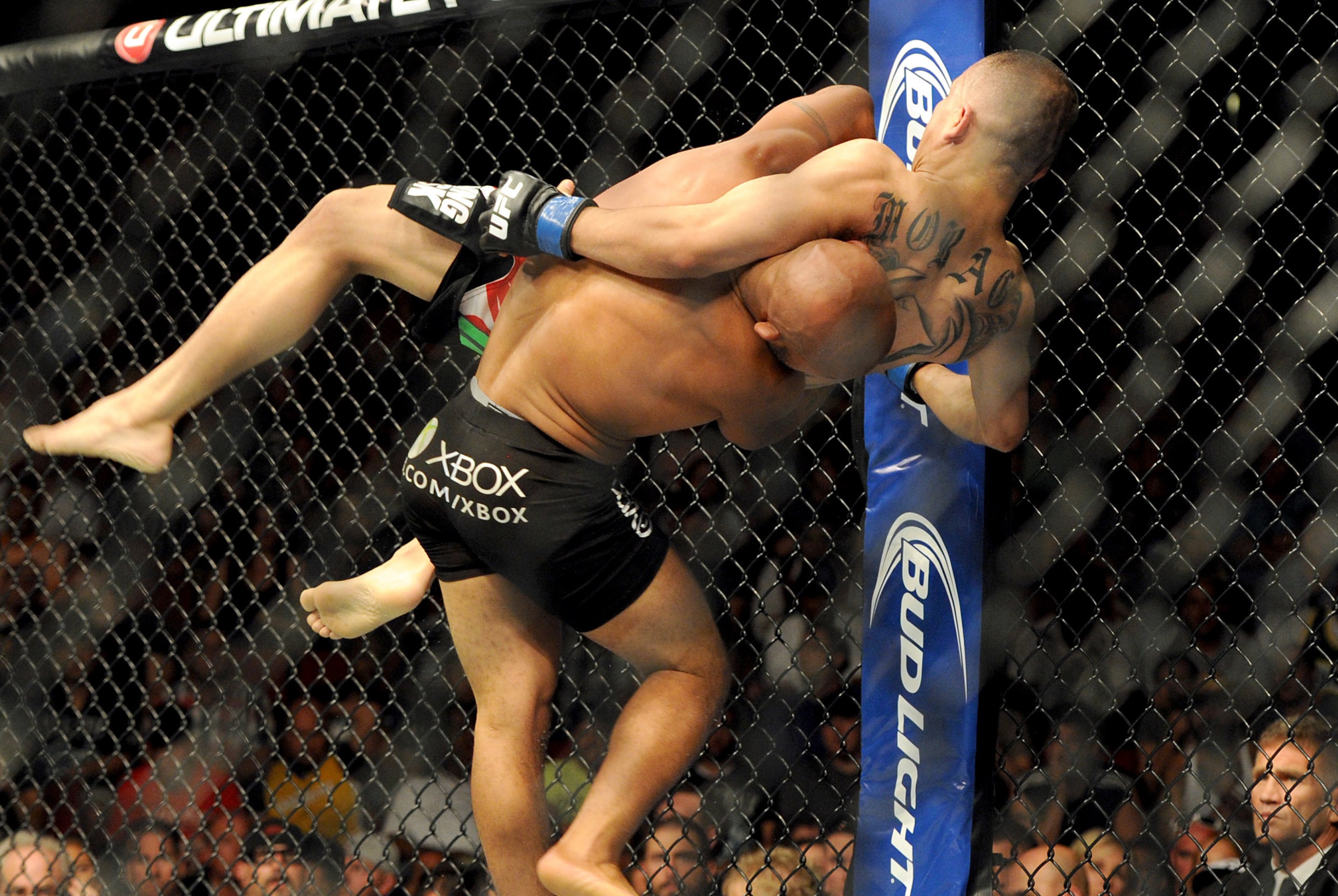 Jul 27, 2013; Seattle, WA, USA;  Demetrious Johnson (red tape) lifts John Moraga (blue tape) during their welterweight bout at Key Arena. Johnson won by a Tap Out. Mandatory Credit: Jayne Kamin-Oncea-USA TODAY Sports