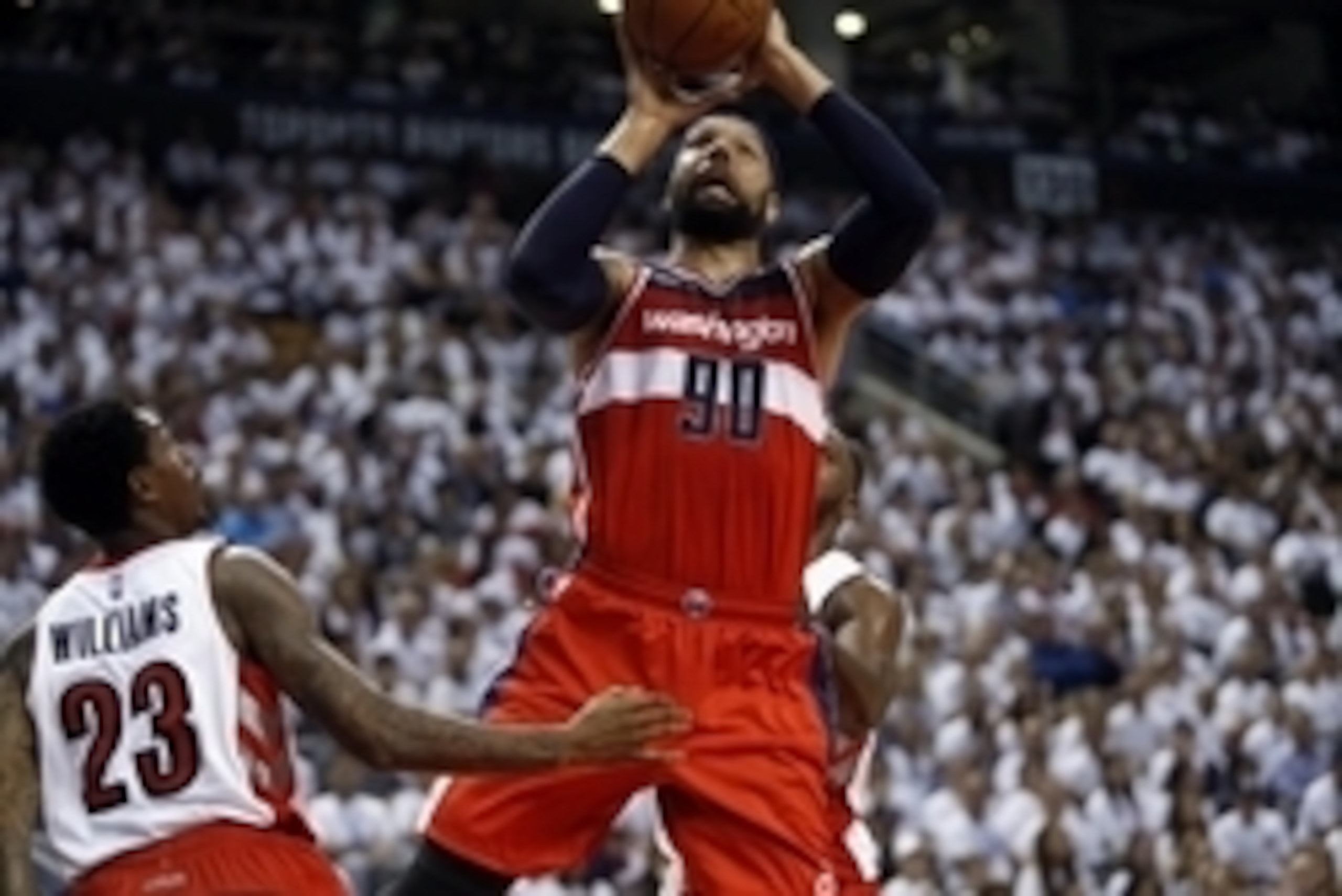 Apr 18, 2015; Toronto, Ontario, CAN; Washington Wizards forward Drew Gooden (90) goes up to make a basket as Toronto Raptors guard Louis Williams (23) looks on in game one of the first round of the NBA Playoffs at Air Canada Centre. Washington defeated To