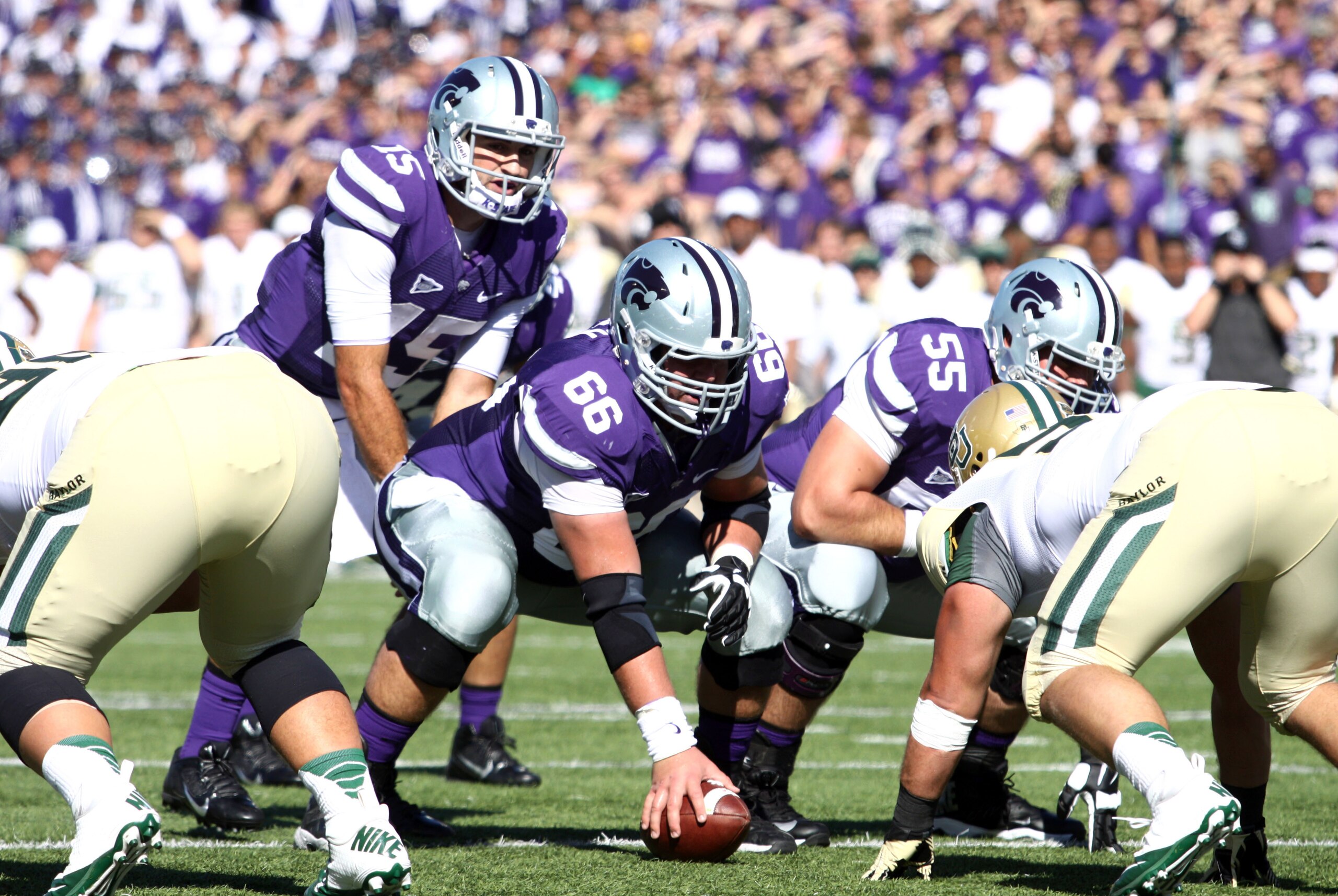 Oct 12, 2013; Manhattan, KS, USA; Kansas State Wildcats quarterback Jake Waters (15) waits to take the snap from center BJ Finney (66) during first-half action against the Baylor Bears at Bill Snyder Family Stadium. Mandatory Credit: Scott Sewell-USA TODA