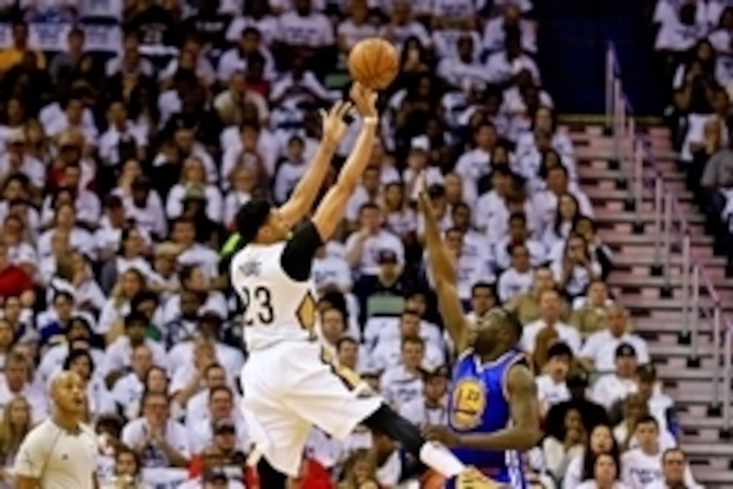 Apr 25, 2015; New Orleans, LA, USA; New Orleans Pelicans forward Anthony Davis (23) shoots over Golden State Warriors forward Draymond Green (23) during the first quarter in game four of the first round of the NBA Playoffs at the Smoothie King Center. Man