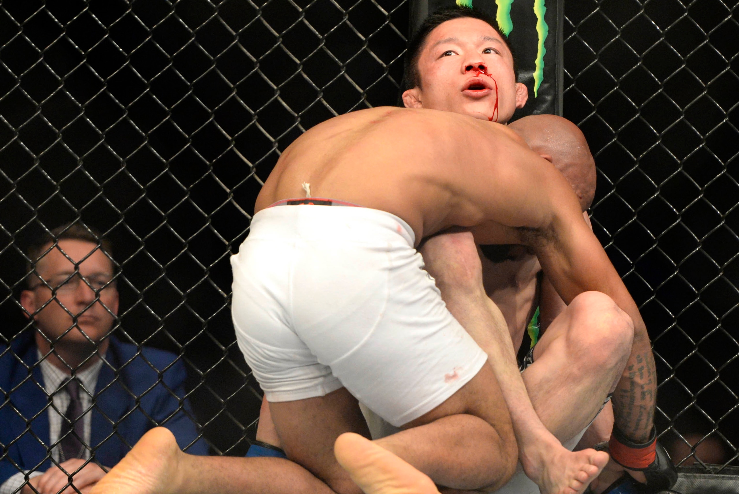 Apr 25, 2015; Montreal, Quebec, CAN; Demetrious Johnson (red) and Kyoji Horiguchi (blue) fight during their flyweight bout during UFC 186 at Bell Centre. Mandatory Credit: Eric Bolte-USA TODAY Sports