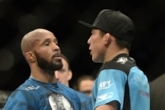 Apr 25, 2015; Montreal, Quebec, CAN; Demetrious Johnson (red) and Kyoji Horiguchi (blue) congratulate each other after their fight during their flyweight bout during UFC 186 at Bell Centre. Mandatory Credit: Eric Bolte-USA TODAY Sports