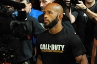 Sep 27, 2014; Las Vegas, NV, USA; Demetrious Johnson walks towards the octagon before he defends his featherweight title against Chris Cariaso during UFC 178 at MGM Grand Garden Arena. Mandatory Credit: Stephen R. Sylvanie-USA TODAY Sports