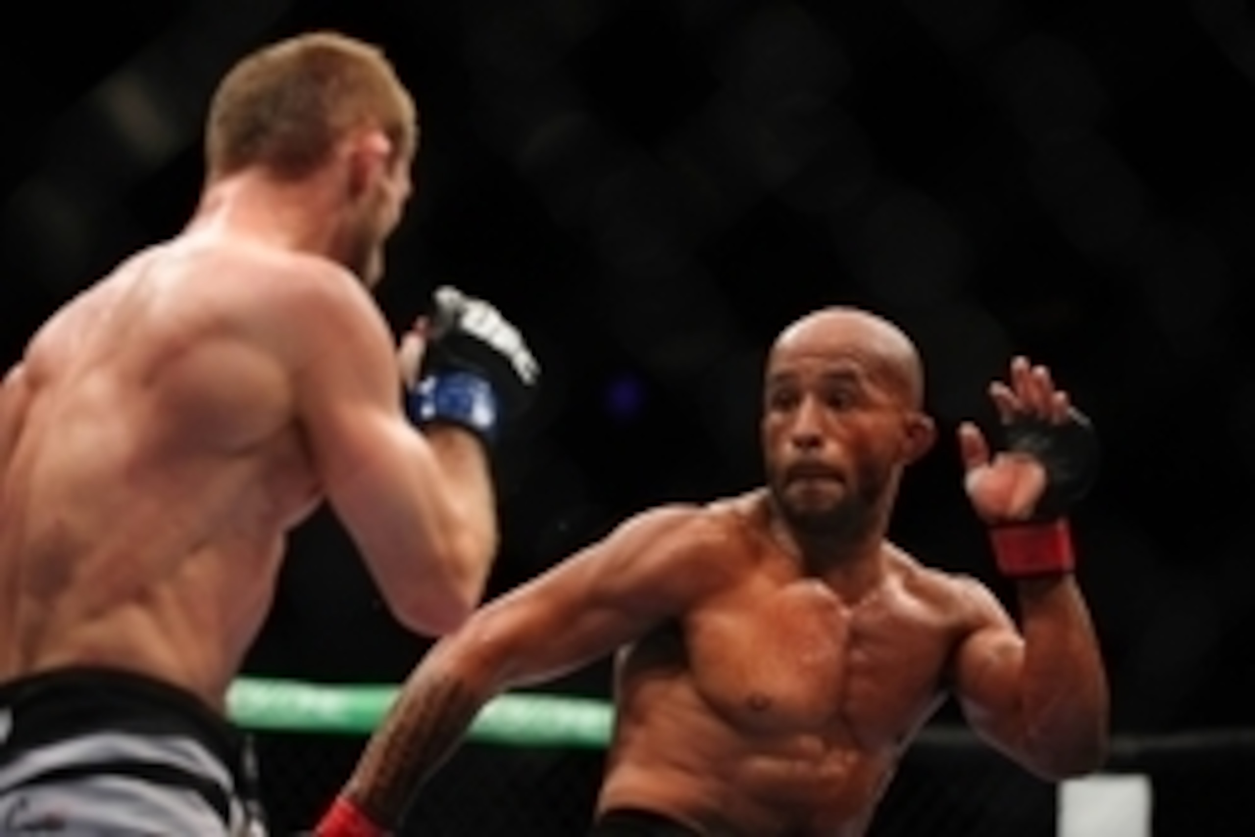 Jun 14, 2014; Vancouver, British Columbia, Canada; Demetrious Johnson (red) fights Ali Bagautinov (blue) in the Flyweight Title bout at UFC 174 at Rogers Arena. Demetrious Johnson defeats Ali Bagautinov via unanimous decision. Mandatory Credit: Anne-Marie Jun 14, 2014; Vancouver, British Columbia, Canada; Demetrious Johnson (red) fights Ali Bagautinov (blue) in the Flyweight Title bout at UFC 174 at Rogers Arena. Demetrious Johnson defeats Ali Bagautinov via unanimous decision. Mandatory Credit: Anne-Marie