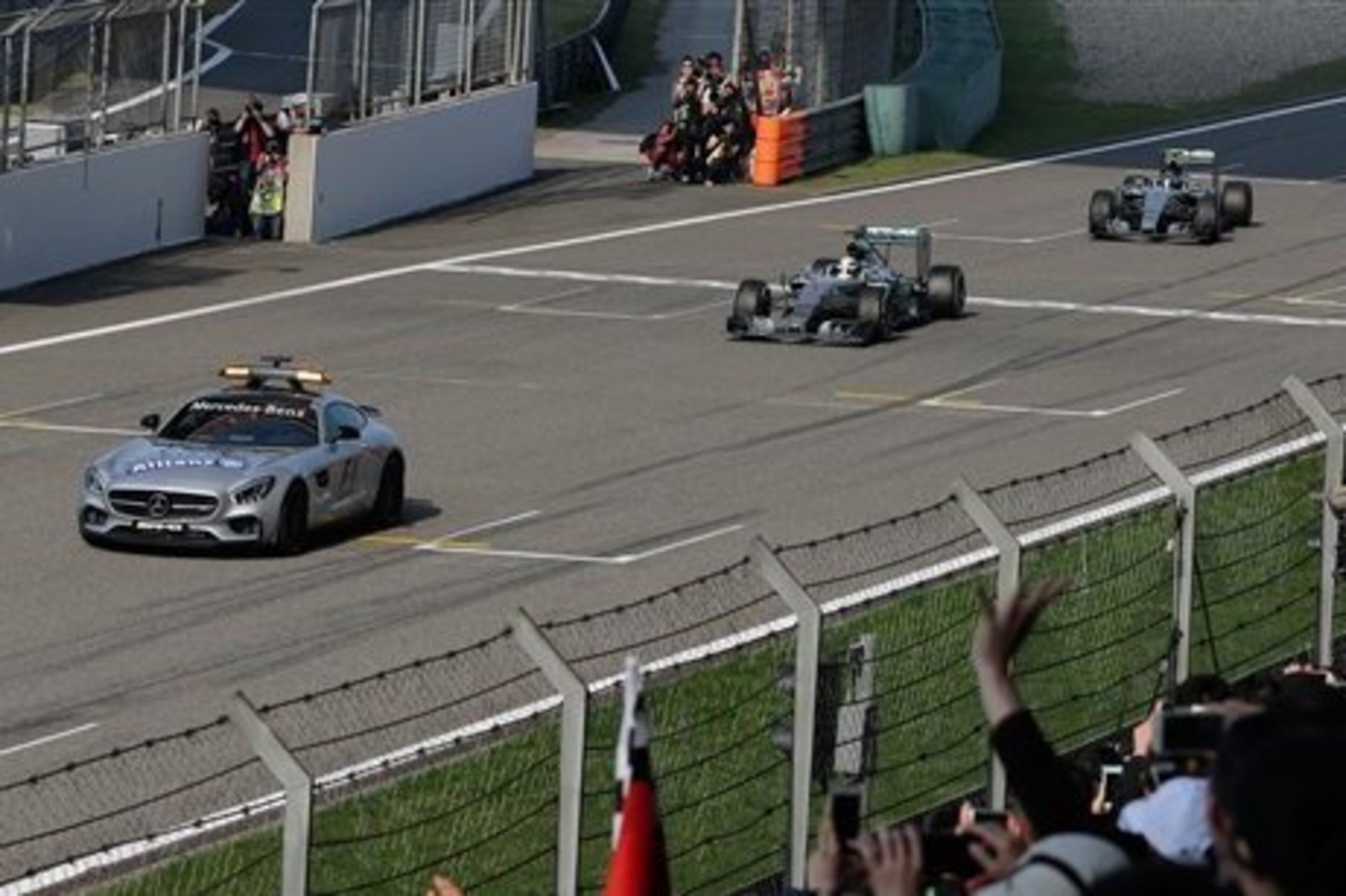 Hamilton and Rsoberg follow the safety car in China. Hamilton and Rsoberg follow the safety car in China.