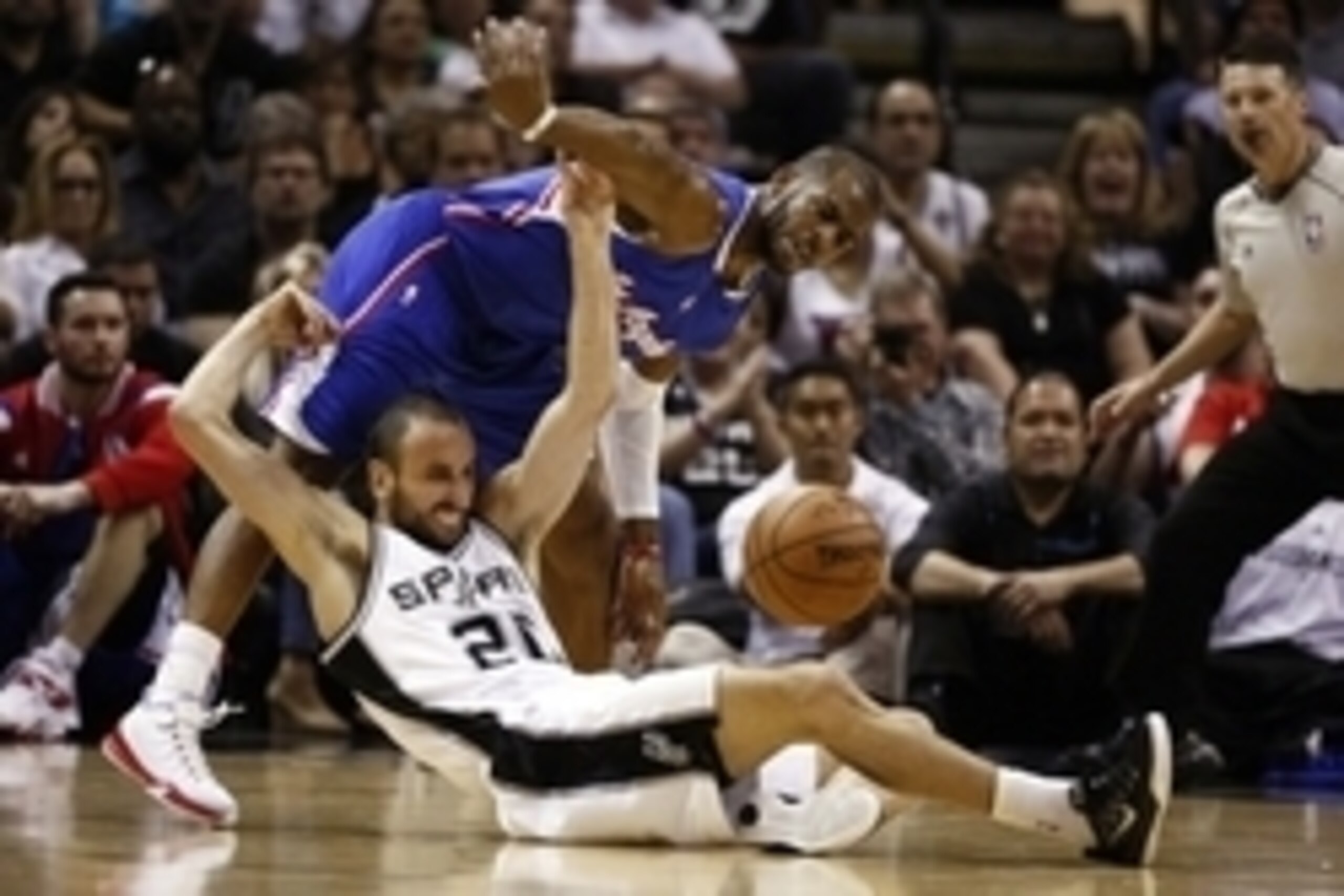 Apr 26, 2015; San Antonio, TX, USA; Los Angeles Clippers point guard Chris Paul (top) and San Antonio Spurs shooting guard Manu Ginobili (20) battle for a loose ball in game four of the first round of the NBA Playoffs at AT&T Center. Mandatory Credit: Soo