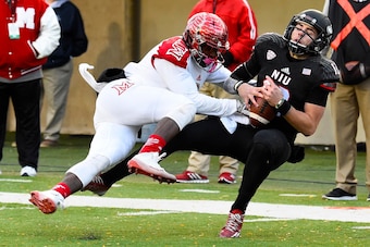 Oct 18, 2014; DeKalb, IL, USA; Northern Illinois Huskies quarterback Drew Hare (12) makes a catch against Miami (Oh) Redhawks defensive back Quinten Rollins (2) during the first half at Huskie Stadium. Mandatory Credit: Mike DiNovo-USA TODAY Sports