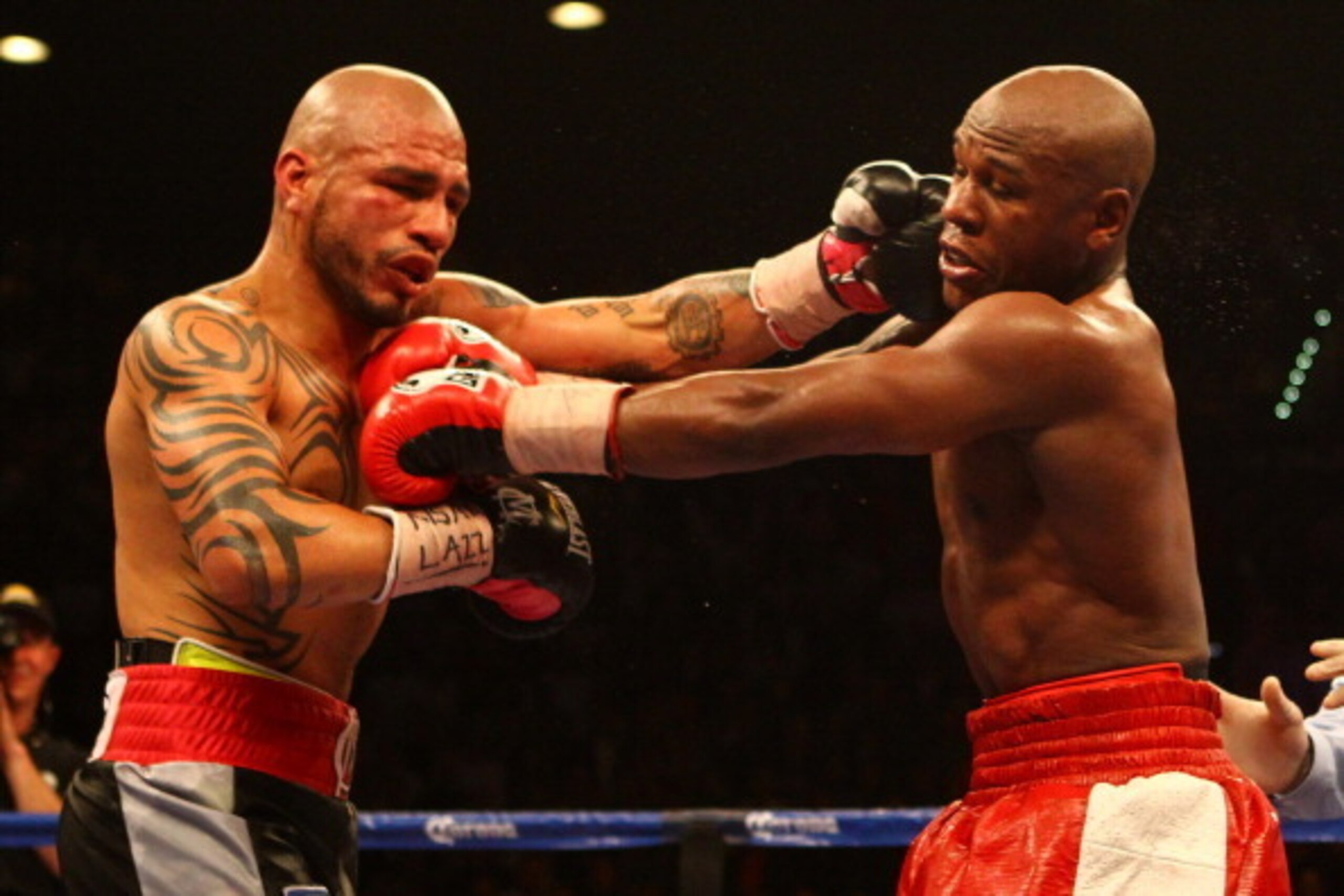 LAS VEGAS, NV - MAY 05:  (L-R) Miguel Cotto and Floyd Mayweather Jr. exchange punches during their WBA super welterweight title fight at the MGM Grand Garden Arena on May 5, 2012 in Las Vegas, Nevada.  (Photo by Al Bello/Getty Images)