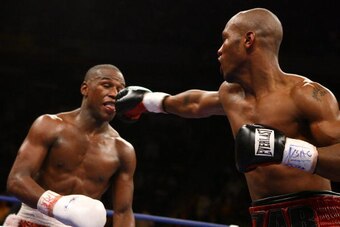 LAS VEGAS - APRIL 08: (L-R) Floyd Mayweather sticks his tounge out as Zab Judah tries to hit him in the mouth in the final round during the Welterweight Championship fight at Thomas & Mack Arena on April 8, 2006 in Las Vegas, Nevada. Mayweather was named 