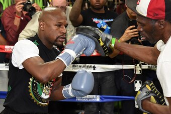 LAS VEGAS, NV - APRIL 14:  WBC/WBA welterweight champion Floyd Mayweather Jr. (L) works out with his uncle Roger Mayweather at the Mayweather Boxing Club on April 14, 2015 in Las Vegas, Nevada. Mayweather Jr. will face WBO welterweight champion Manny Pacq
