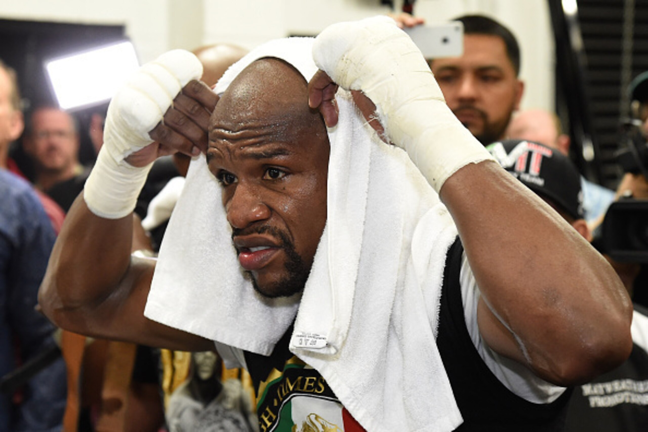 LAS VEGAS, NV - APRIL 14:  WBC/WBA welterweight champion Floyd Mayweather Jr. puts a towel over his head as he works out at the Mayweather Boxing Club on April 14, 2015 in Las Vegas, Nevada. Mayweather will face WBO welterweight champion Manny Pacquiao in