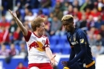 Apr 26, 2015; Harrison, NJ, USA; New York Red Bulls midfielder Dax McCarty (11) reacts before Los Angeles Galaxy forward Bradford Jamieson (38) is called for hand ball during second half at Red Bull Arena. Final score 1-1.  Mandatory Credit: Noah K. Murra